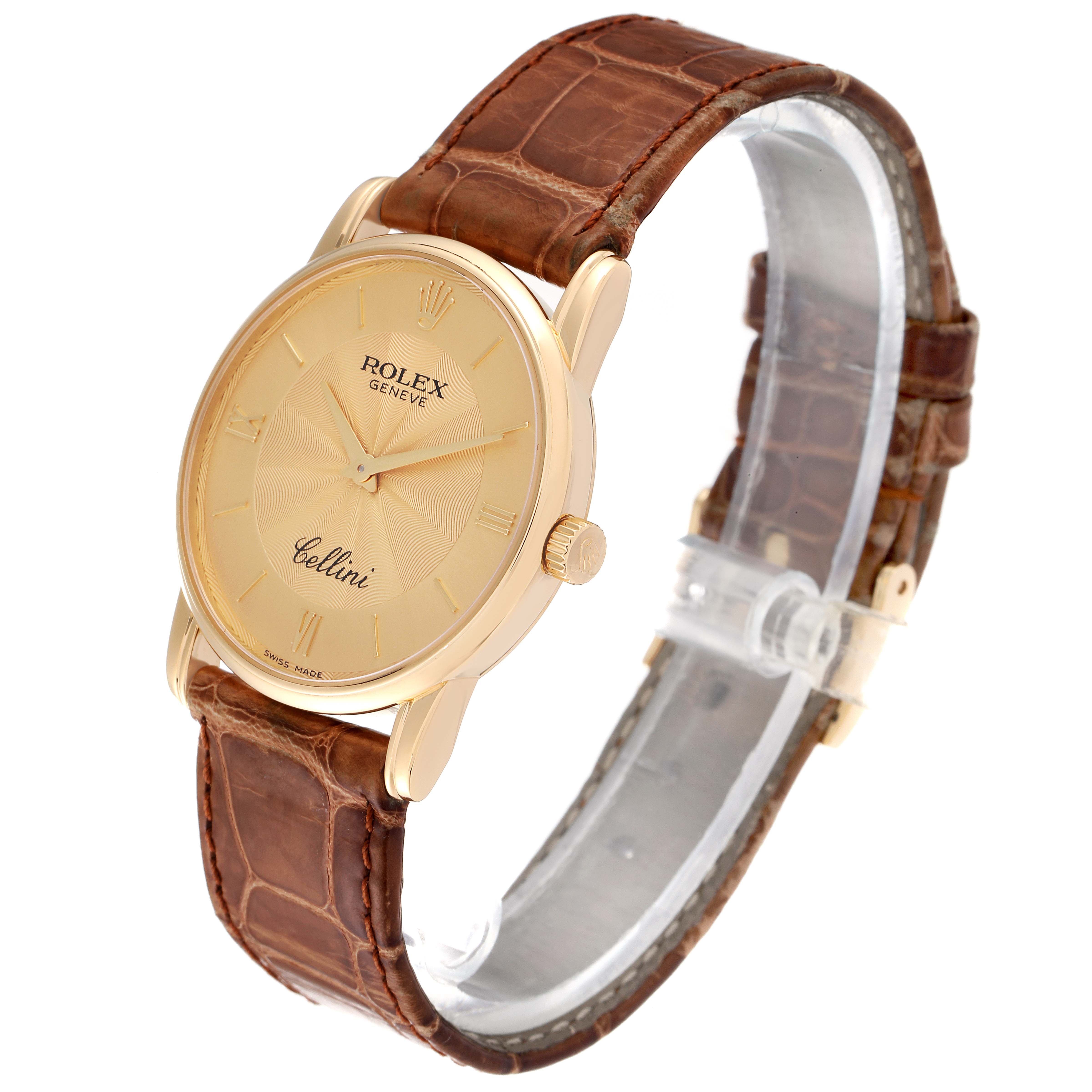 The Rolex Cellini 5116 Men's Yellow Gold Champagne Dial 5116 Men's Yellow Gold Champagne Dial watch is shown from a three-quarter angle, highlighting its gold case, brown leather strap, and dial.