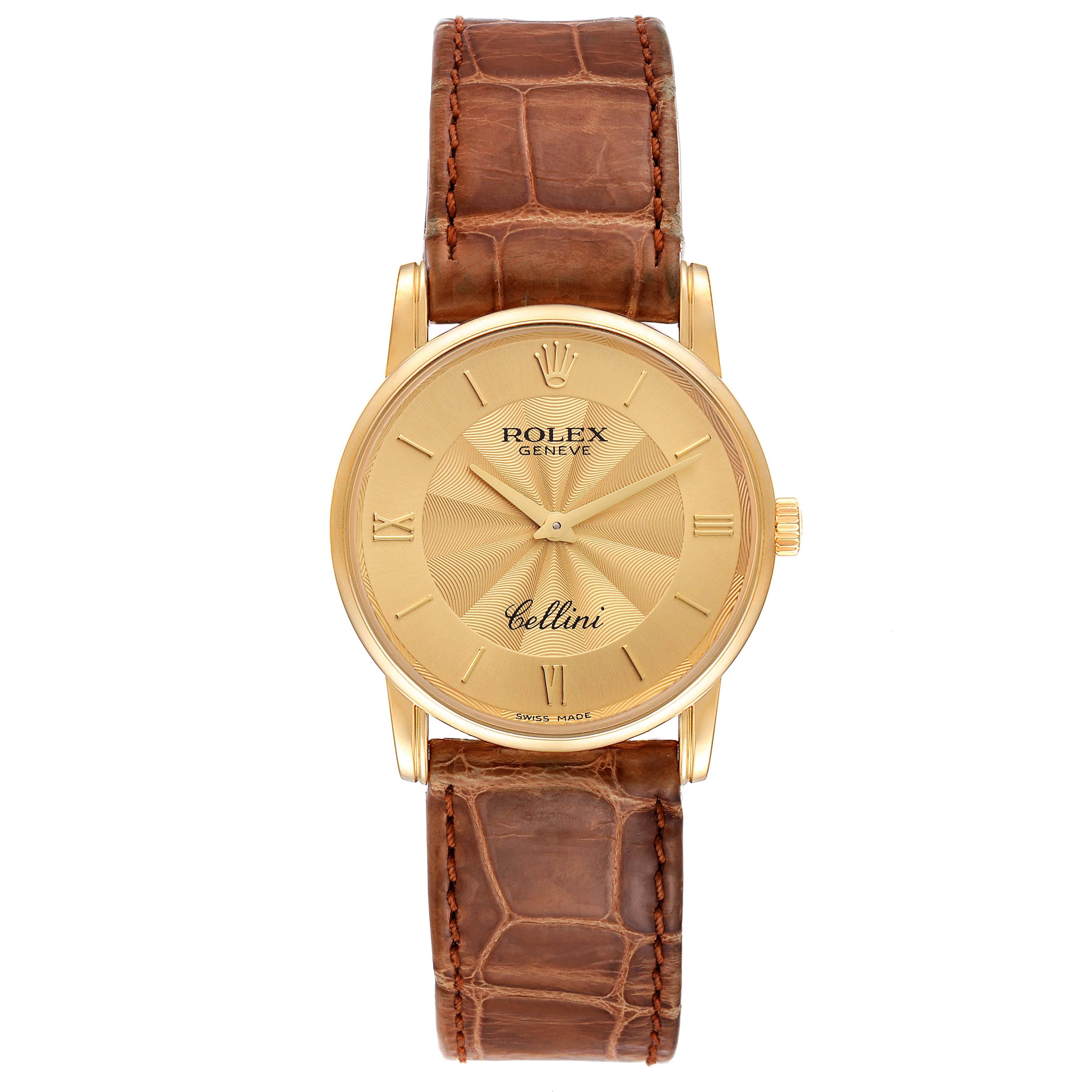 The Rolex Cellini 5116 Men's Yellow Gold Champagne Dial 5116 Men's Yellow Gold Champagne Dial watch is shown from a top-down angle, displaying its gold dial, Roman numerals, and brown leather strap.