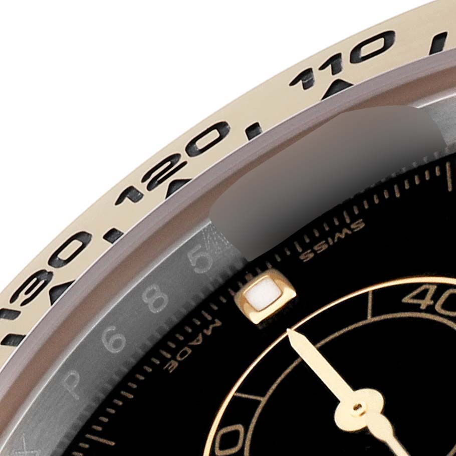 This close-up shows the bezel and part of the dial of a Rolex Daytona 116503 Men's Steel and Gold (two tone) Black Dial 116503 Men's Steel and Gold (two tone) Black Dial watch.