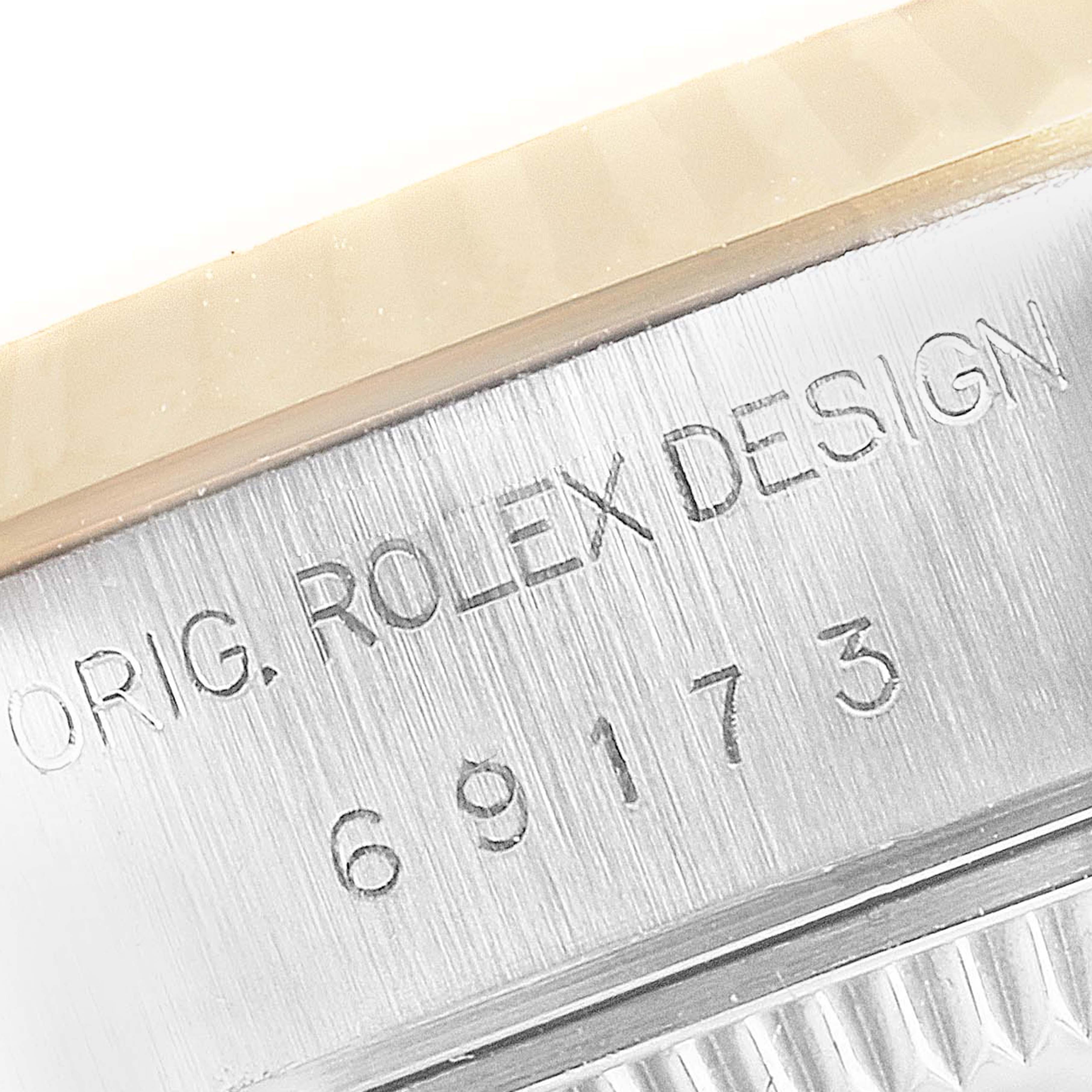 This image shows a close-up of the side engraving on a Rolex Datejust 69173 Women's Steel and Gold (two tone) Blue Dial 69173 Women's Steel and Gold (two tone) Blue Dial watch, focusing on the serial number and the text "ORIG. ROLEX DESIGN".