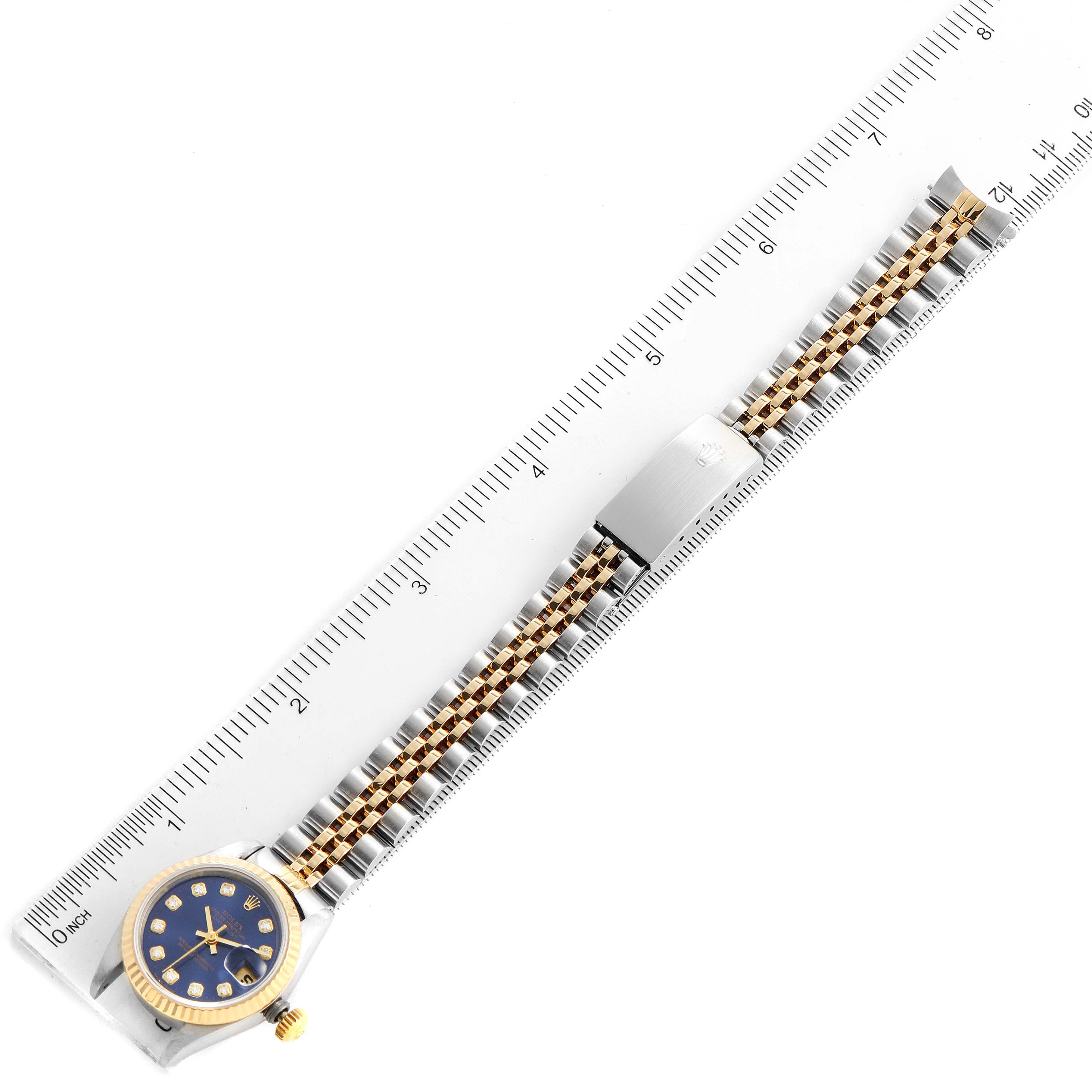 The image shows a Rolex Datejust 69173 Women's Steel and Gold (two tone) Blue Dial 69173 Women's Steel and Gold (two tone) Blue Dial watch laid flat with a metal ruler, displaying its face, bezel, and bracelet.