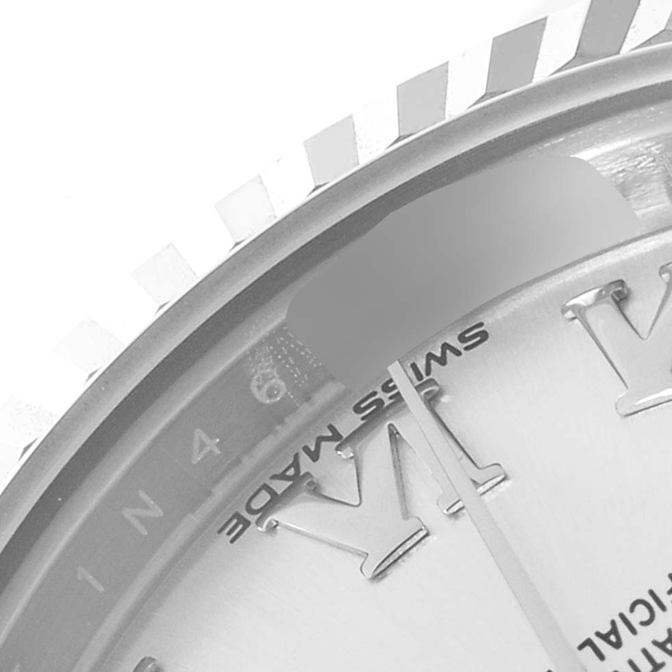 The image shows a close-up of a Rolex Datejust 279174 Women's Stainless Steel Silver Dial 279174 Women's Stainless Steel Silver Dial watch, highlighting the fluted bezel, part of the dial, and Roman numeral hour markers.