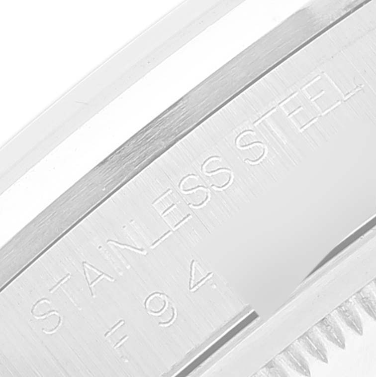 This image shows a close-up of the stainless steel inscription on the side of a Rolex Datejust 16200 Men's Stainless Steel Silver Dial 16200 Men's Stainless Steel Silver Dial watch.
