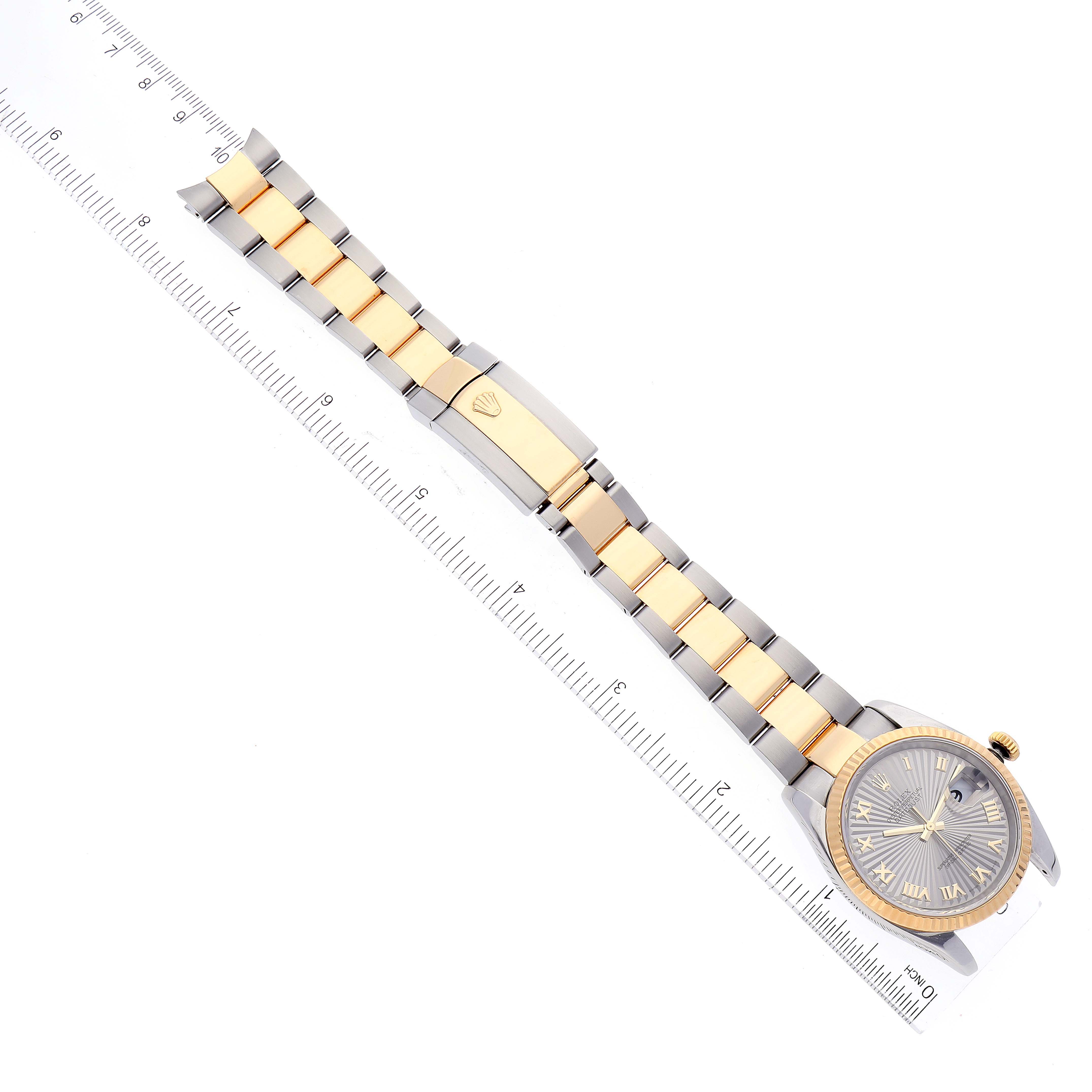 The image shows a Rolex Datejust 116233 Men's Steel and Gold (two tone) Grey Dial 116233 Men's Steel and Gold (two tone) Grey Dial watch laying flat with the face and full bracelet visible next to a ruler for scale.