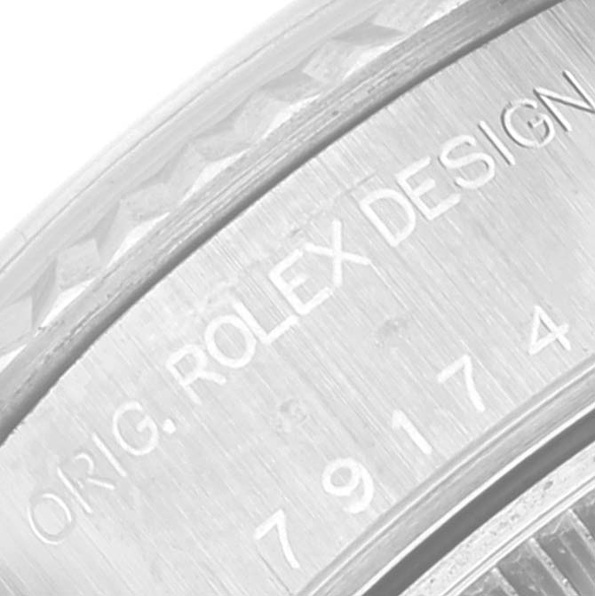 The image shows a close-up of the Datejust model by Rolex, focusing on the engraved design and part of the model number.