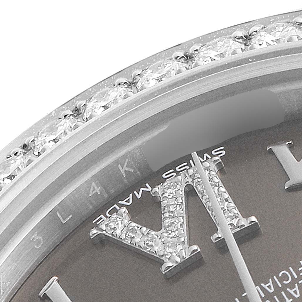 This close-up shows the bezel, part of the dial, and diamond-set Roman numerals of a Rolex Mid-Size 178384 Women's Stainless Steel Brown Dial 178384 Women's Stainless Steel Brown Dial watch.