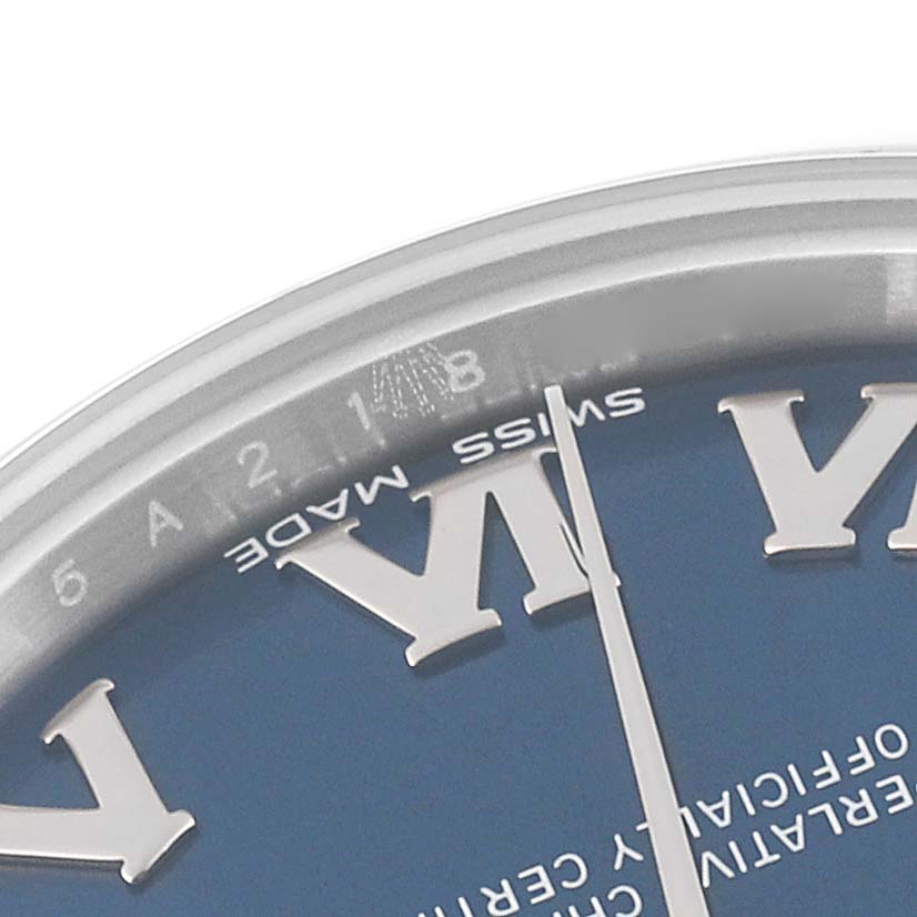 This image shows a close-up of the dial, hands, and part of the bezel of a Mid-Size Rolex watch.