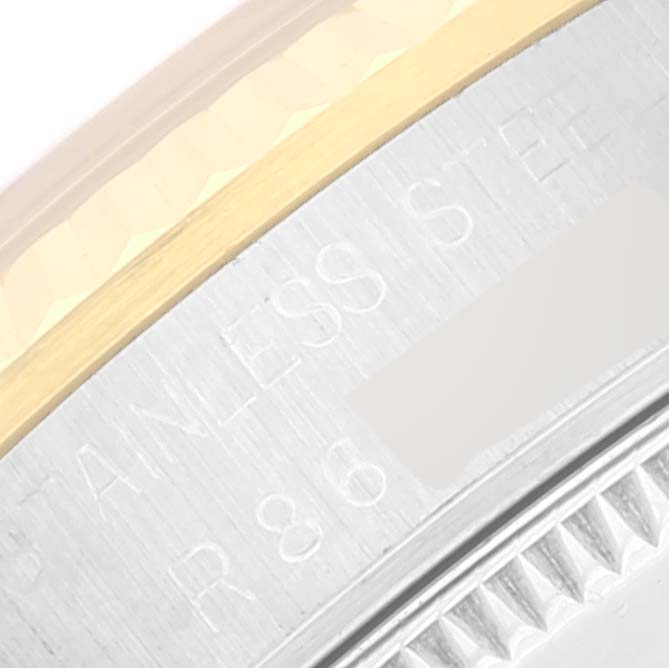 The image shows a close-up angle of the bezel and case edge of a mid-size Rolex watch.