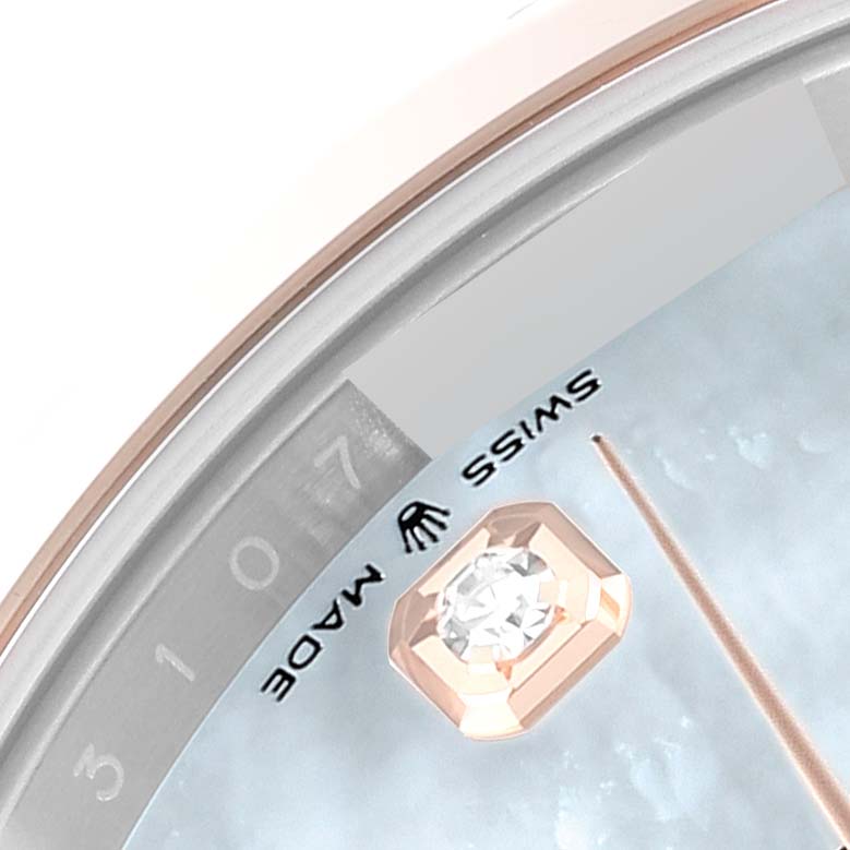 This close-up shot of the Rolex Datejust 41 126301 Men's Steel and Gold (two tone) Mother of Pearl Dial 126301 Men's Steel and Gold (two tone) Mother of Pearl Dial watch highlights part of the bezel, date display, and a diamond hour marker.