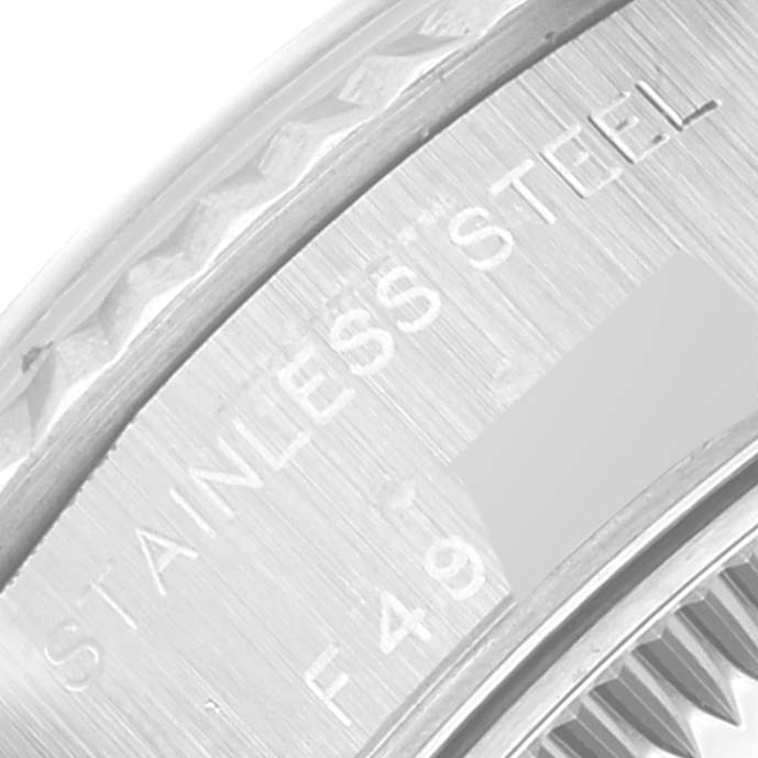 This close-up image shows a portion of the Rolex Datejust 79174 Women's Stainless Steel Blue Dial 79174 Women's Stainless Steel Blue Dial watch's stainless steel case, focusing on the engraved text.