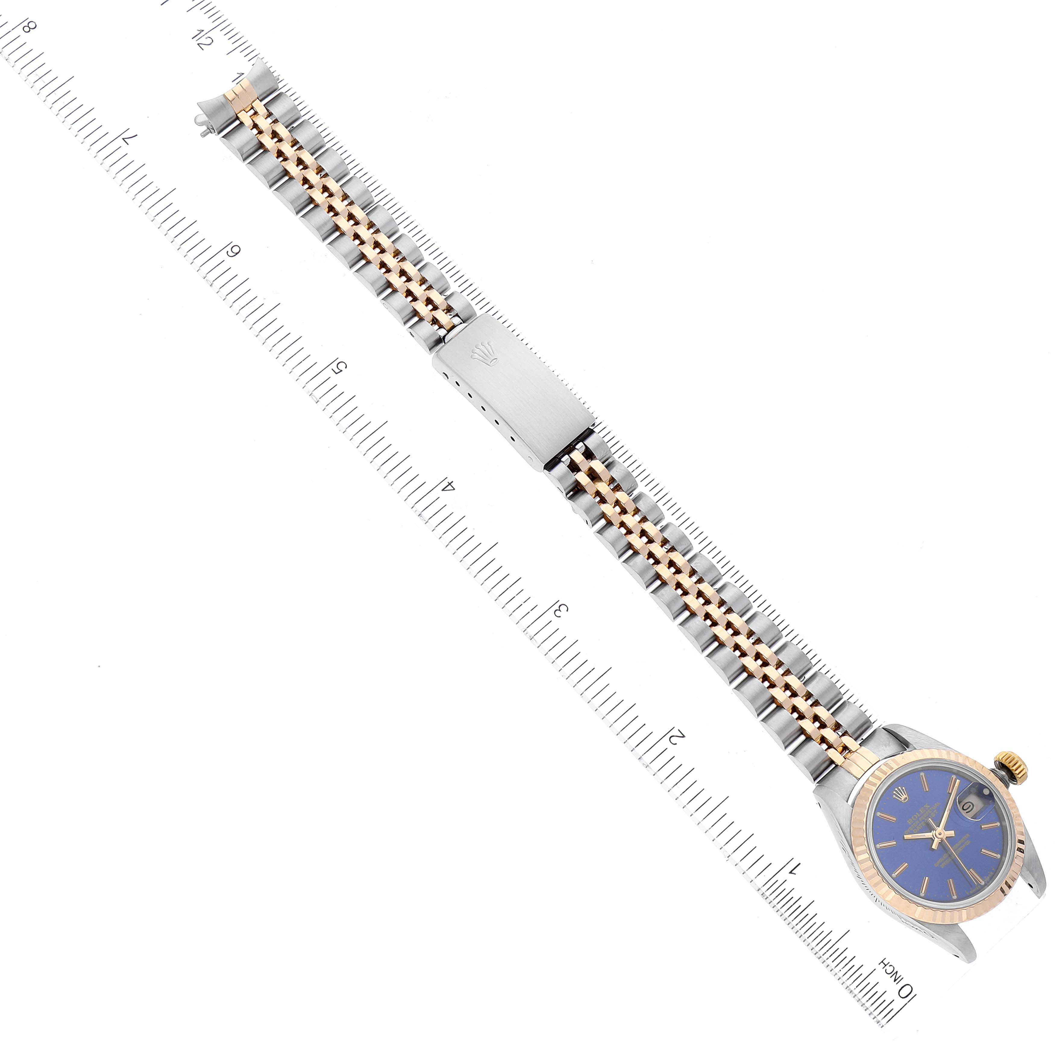 The image shows a Rolex Datejust 69173 Women
s Steel and Gold (two tone) Blue Dial 69173 Women
s Steel and Gold (two tone) Blue Dial watch laid flat, featuring its two-tone bracelet and a blue dial.