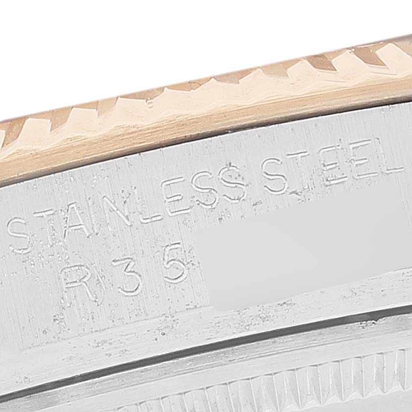 This is a close-up shot of the case side and part of the bezel of a Rolex Datejust 16013 Men
s Steel and Gold (two tone) Silver Dial 16013 Men
s Steel and Gold (two tone) Silver Dial model, showing the stainless steel engraving.