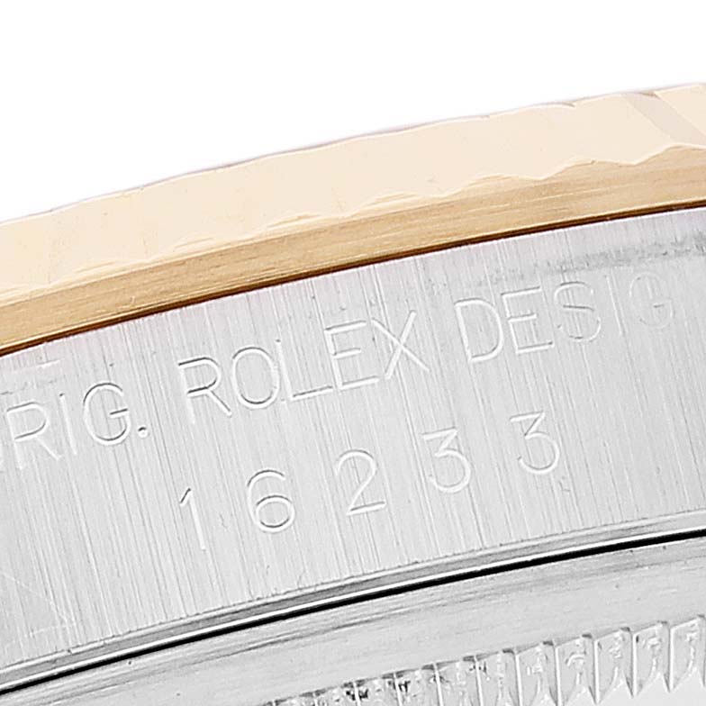The image shows a close-up angle of the side of a Rolex Datejust 16233 Men's Steel and Gold (two tone) White Dial 16233 Men's Steel and Gold (two tone) White Dial model, highlighting its bezel and case with engravings.
