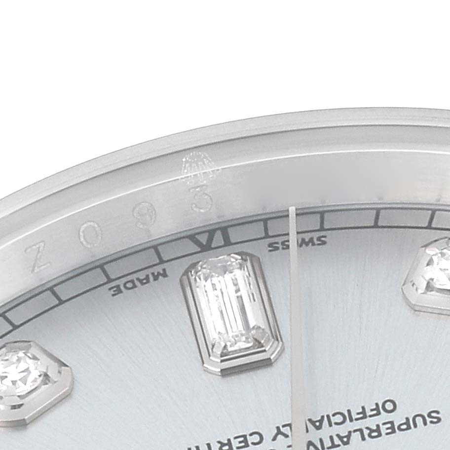 This close-up image of a Rolex President 118206 Men's Platinum Blue Dial 118206 Men's Platinum Blue Dial model watch shows the bejeweled hour markers, minute hand, and "Swiss Made" inscription.