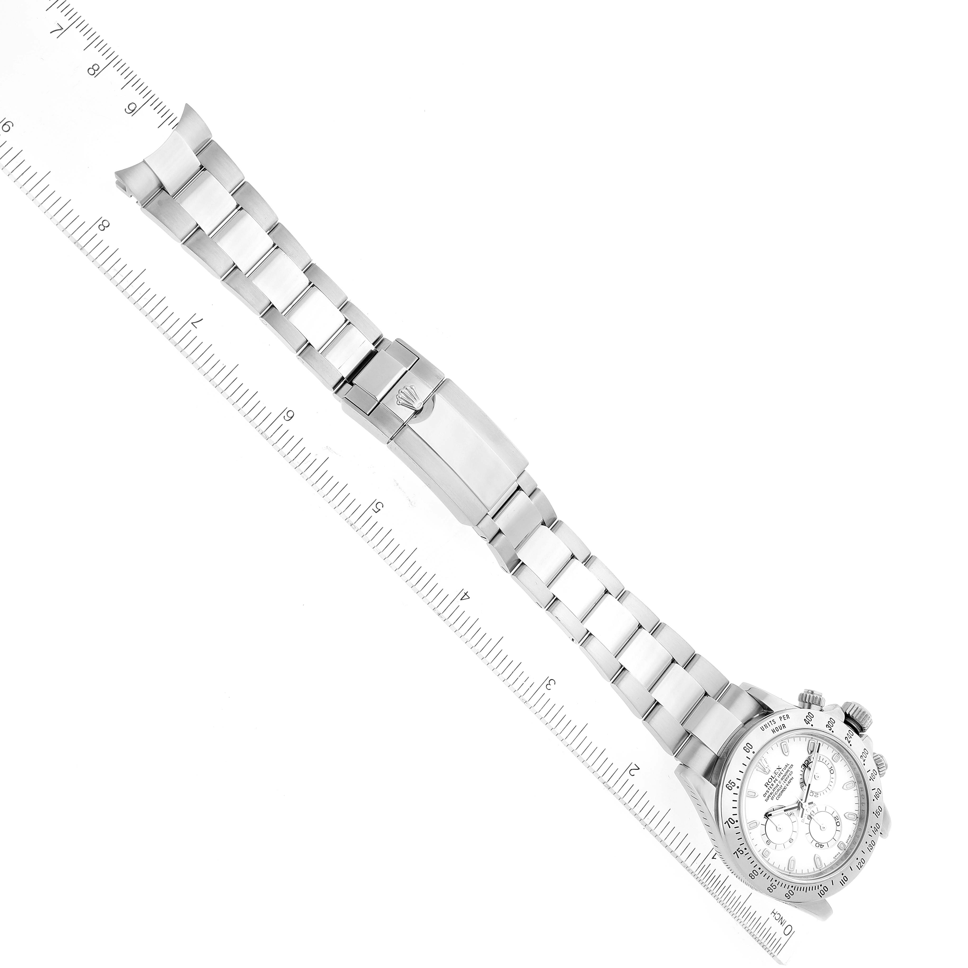 This image shows the Rolex Daytona 116520 Men's Stainless Steel White Dial 116520 Men's Stainless Steel White Dial watch, including the face, bezel, and full bracelet, laid out alongside a ruler for measurement.