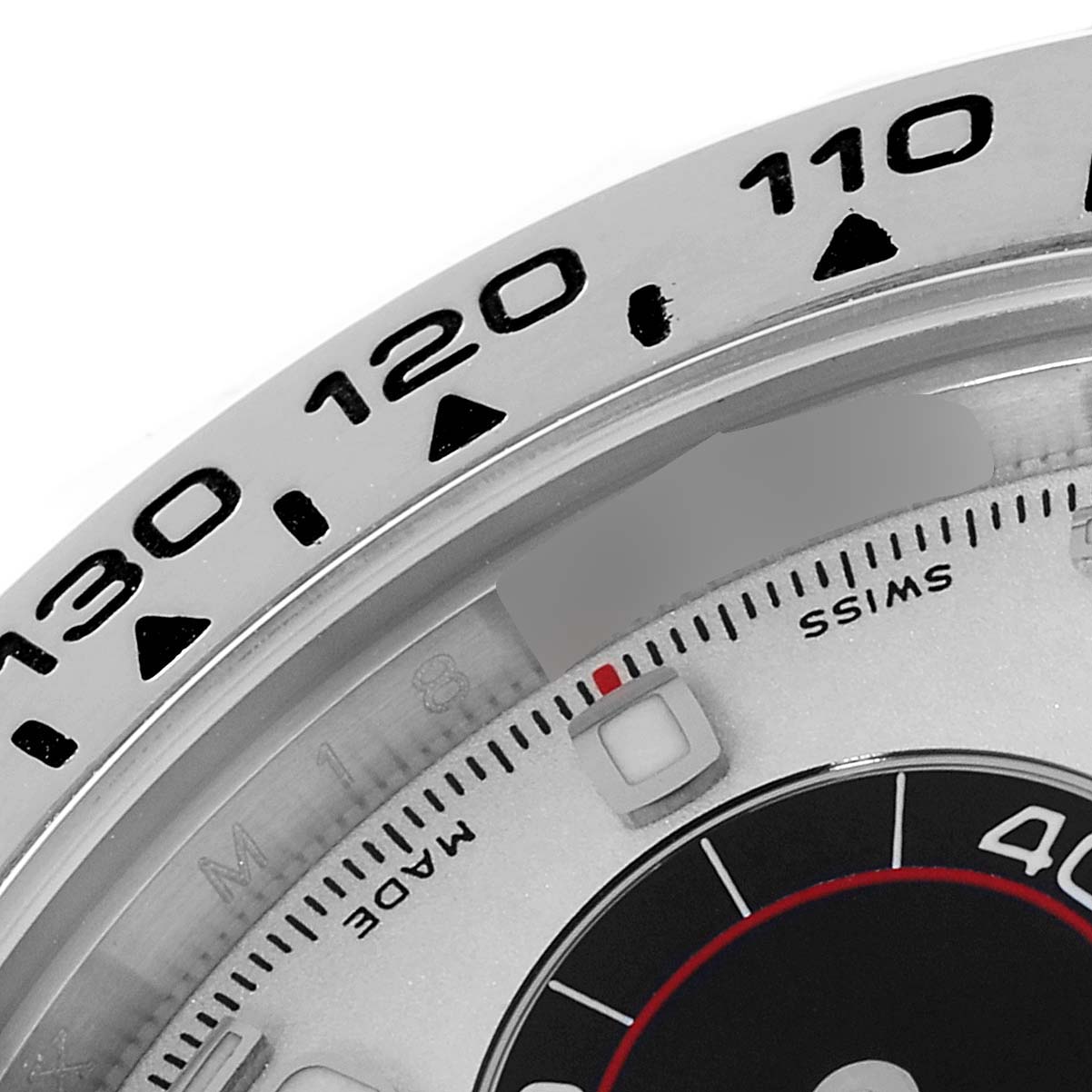 The image shows a close-up of the bezel and part of the dial of the Rolex Daytona 116519 Men's White Gold Silver Dial 116519 Men's White Gold Silver Dial watch, focusing on numerals and markers.