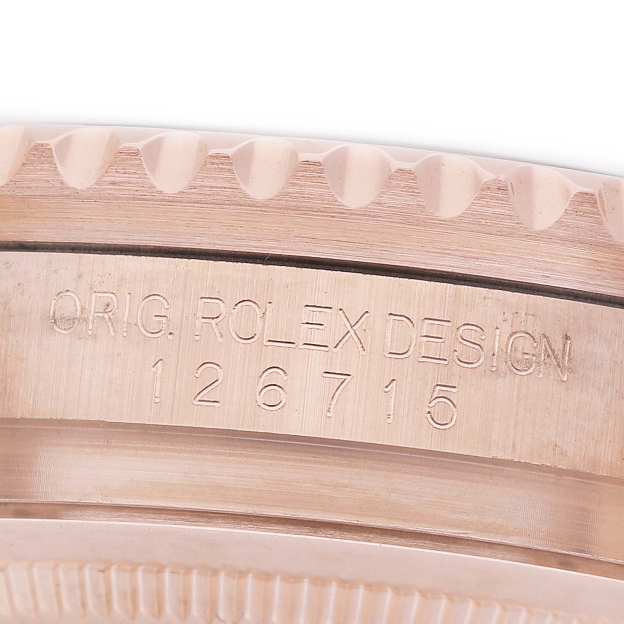 The image shows a close-up of the side of a Rolex GMT-Master 126715 Men's Rose Gold Black Dial watch case, highlighting its serrated edge and engraved serial number.