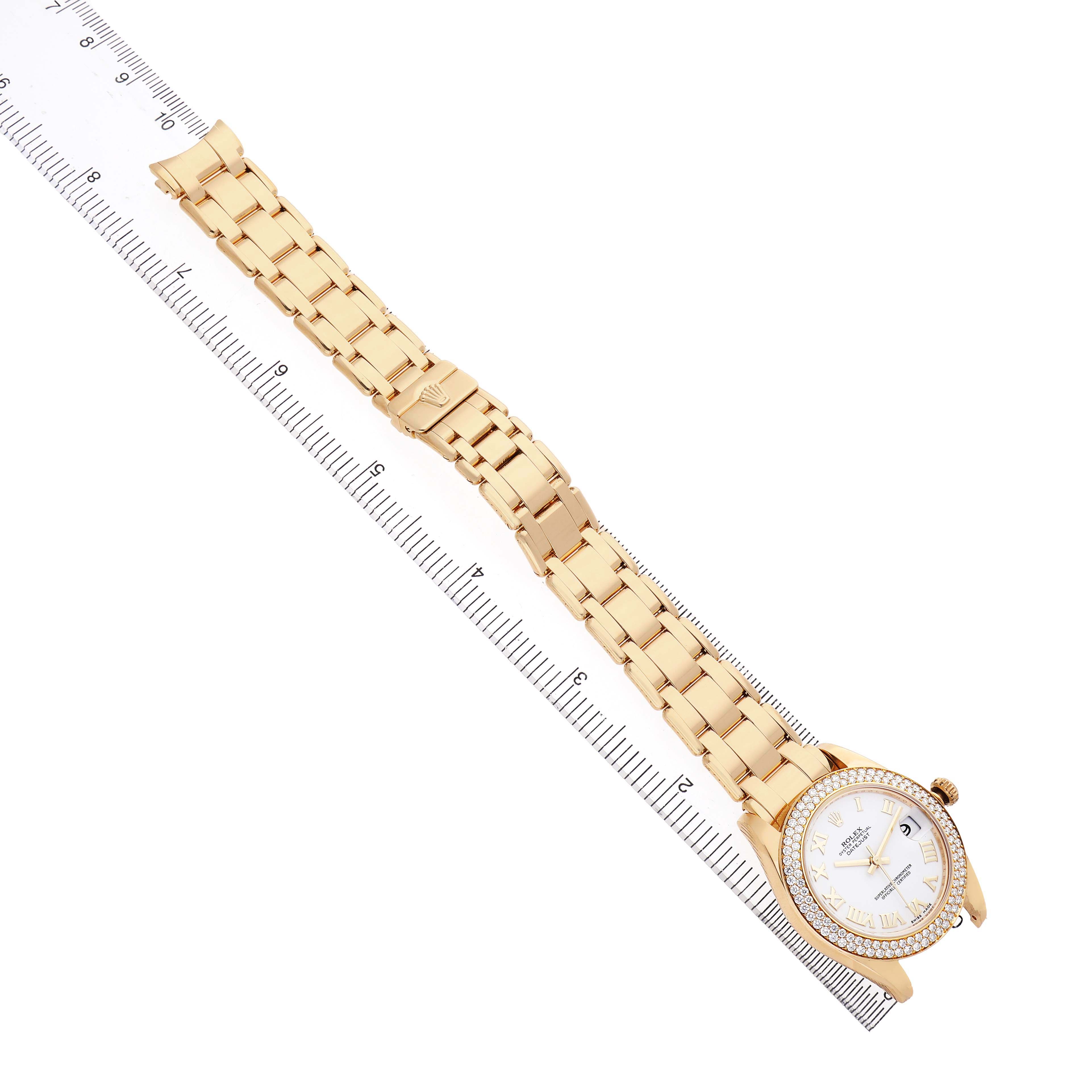 The Rolex Pearlmaster 81338 Women's Yellow Gold White Dial watch is shown at an angle displaying the full bracelet and case, with a ruler for scale.