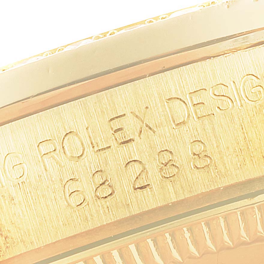 This close-up image shows the engraved side markings of a Rolex President 68288 Women's Yellow Gold Beige Dial 68288 Women's Yellow Gold Beige Dial watch case.