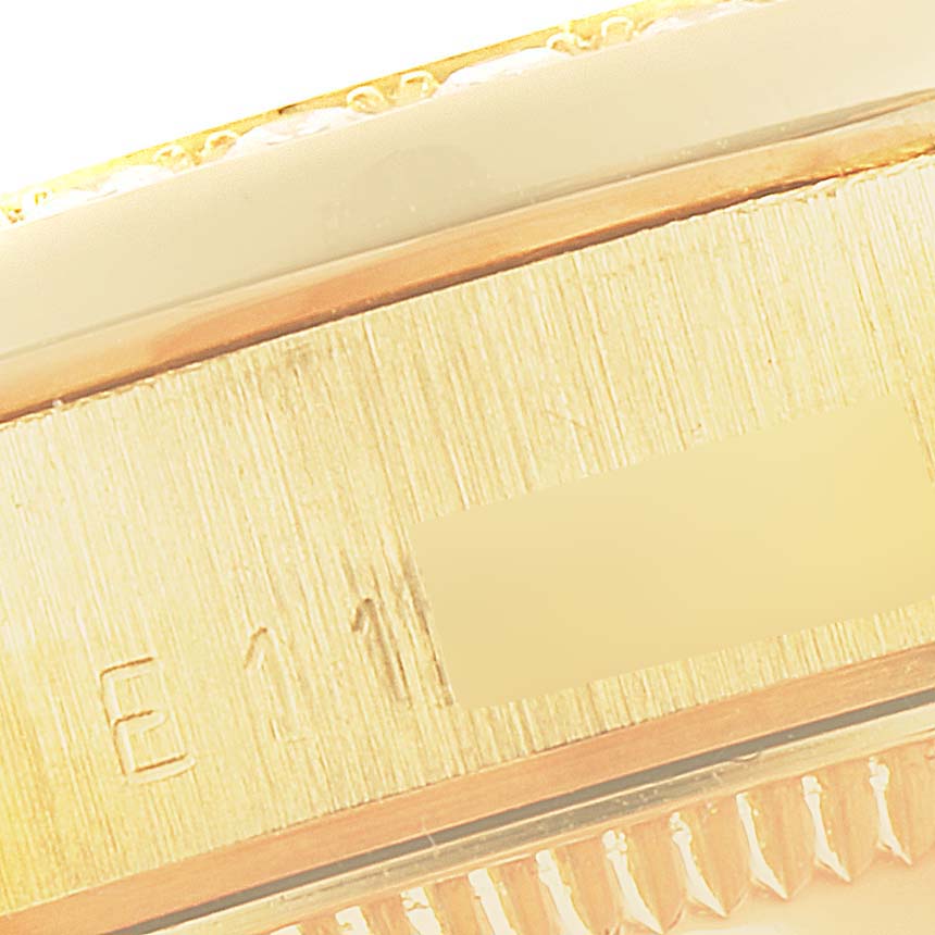 This image shows a close-up of the engraved side and fluted bezel of a Rolex President 68288 Women's Yellow Gold Beige Dial 68288 Women's Yellow Gold Beige Dial model watch.