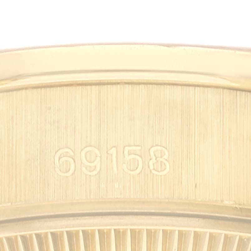 This is a close-up of the case back of a Rolex President 69158 Women
s Yellow Gold Champagne Dial 69158 Women
s Yellow Gold Champagne Dial model watch showing the engraved model number "69158."