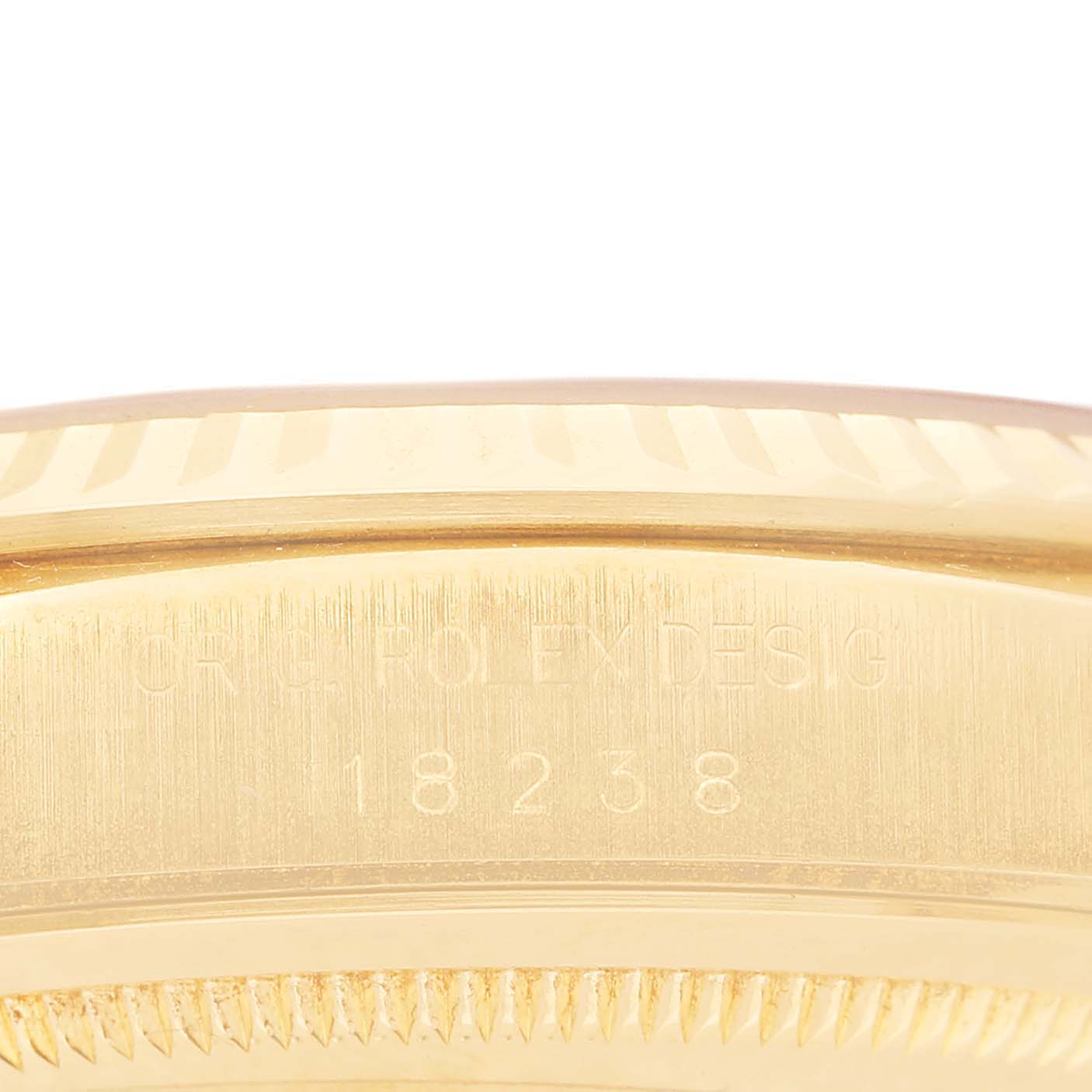 This image shows the side engraving on the bezel of a Rolex President 18238 Men's Yellow Gold Champagne Dial model watch.