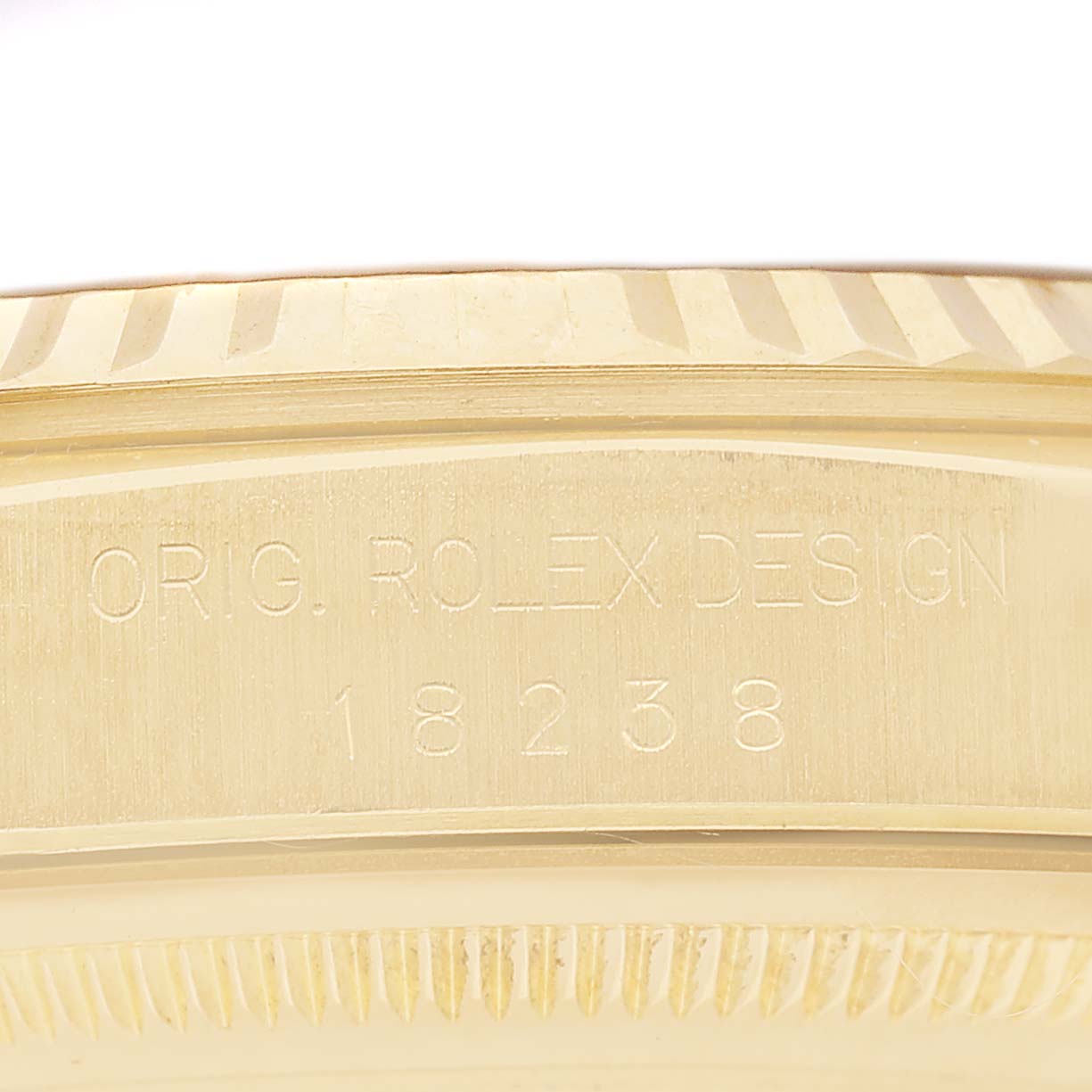 The image shows a close-up of the case side and bezel of a Rolex President 18238 Men's Yellow Gold White Dial watch model, highlighting engravings.