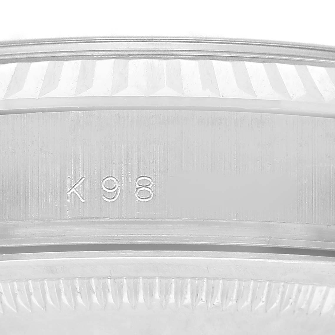 The image shows a close-up of the inner bezel of a Rolex President 118209 Men's White Gold Silver Dial model, displaying engraved markings.