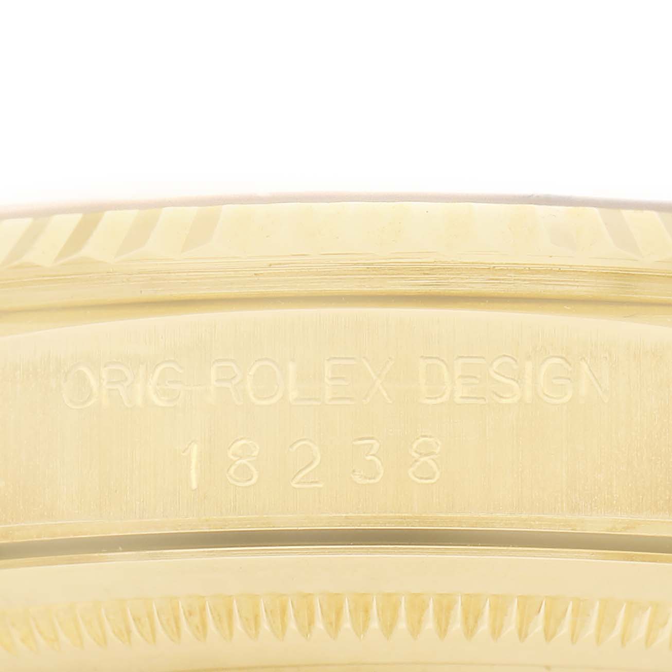 The image shows the side engraving on the bezel of a Rolex President 18238 Men's Yellow Gold Champagne Dial model watch, displaying "ORIG-ROLEX DESIGN 18238."