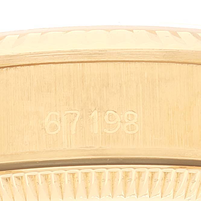 This image shows the side of a Rolex Pearlmaster 67198 Women
s Yellow Gold Black Dial 67198 Women
s Yellow Gold Black Dial watch, focusing on its model number engraved on the bezel.