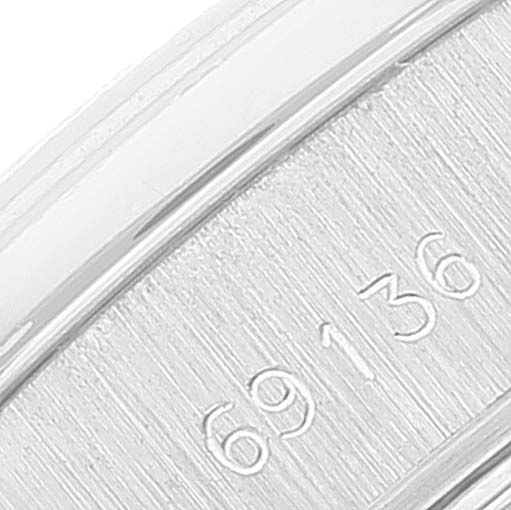 This close-up image of the Rolex President 69136 Women's Platinum Silver Dial 69136 Women's Platinum Silver Dial watch shows a portion of its case with the model number "69136" engraved on it.