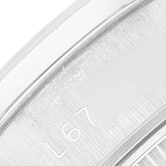 This close-up image shows a partial view of the bezel and dial of the President model by Rolex.