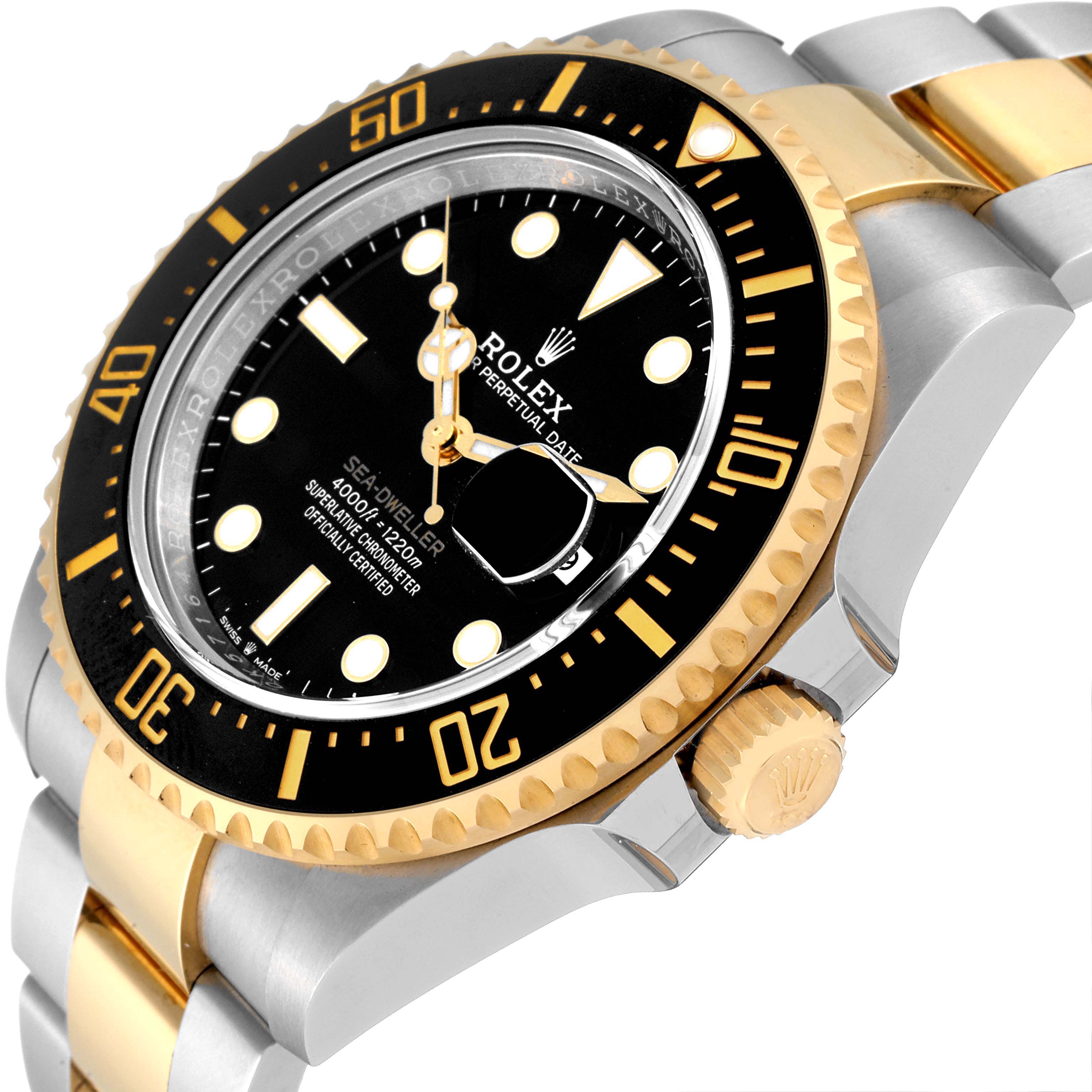The image shows an angled view of the Rolex Sea-Dweller 126603 Men's Steel and Gold (two tone) Black Dial 126603 Men's Steel and Gold (two tone) Black Dial watch, highlighting its bezel, dial, and part of the bracelet.
