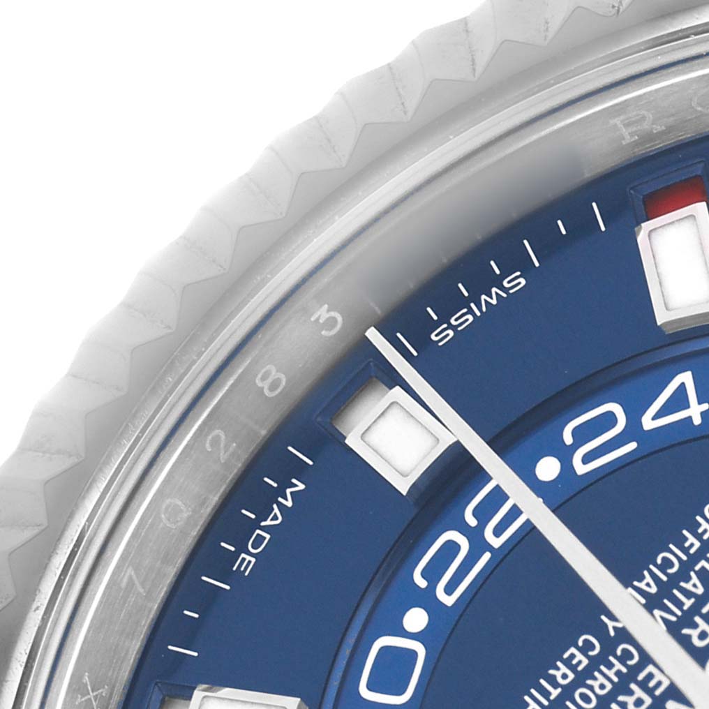 The image shows a close-up of the blue dial and fluted bezel of a Rolex Sky-Dweller 326934 Men's Stainless Steel Blue Dial, focusing on markers and text.