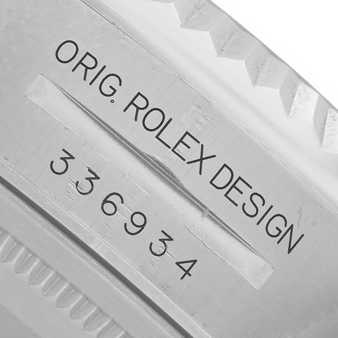 The image shows a close-up of the side of a Rolex Sky-Dweller 336934 Men's Stainless Steel Green Dial watch, highlighting the engraved model number and design details.