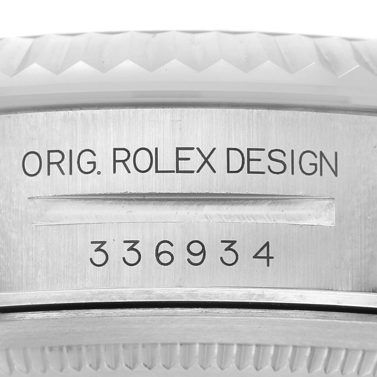 The image shows a close-up of the side of a Rolex Sky-Dweller 336934 Men's Stainless Steel Green Dial watch, featuring the bezel and engraved design reference.