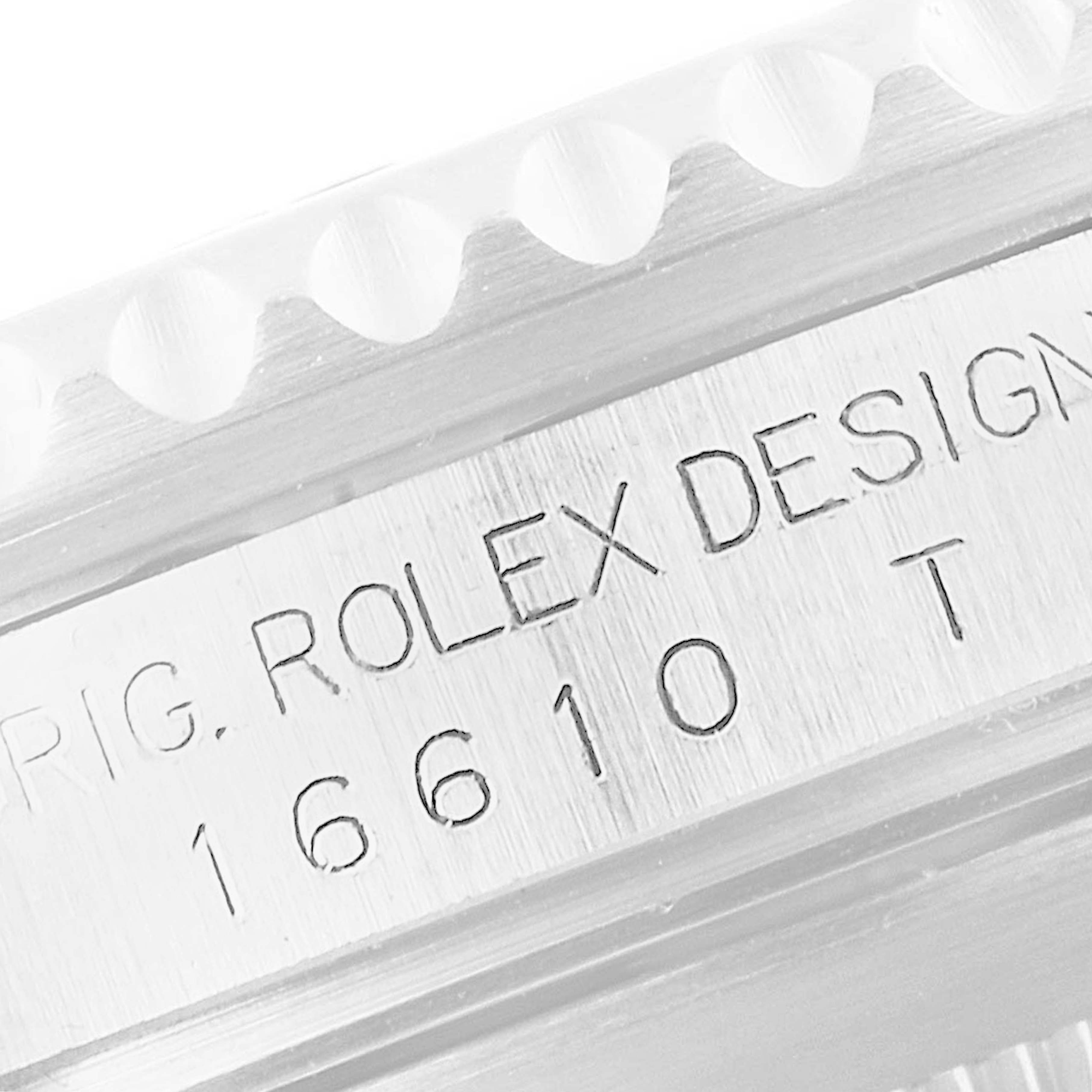 This close-up image shows the engraved model number "16610T" and the "Rolex Design" insignia on a Rolex Submariner 16610 Men's Stainless Steel Black Dial 16610 Men's Stainless Steel Black Dial.