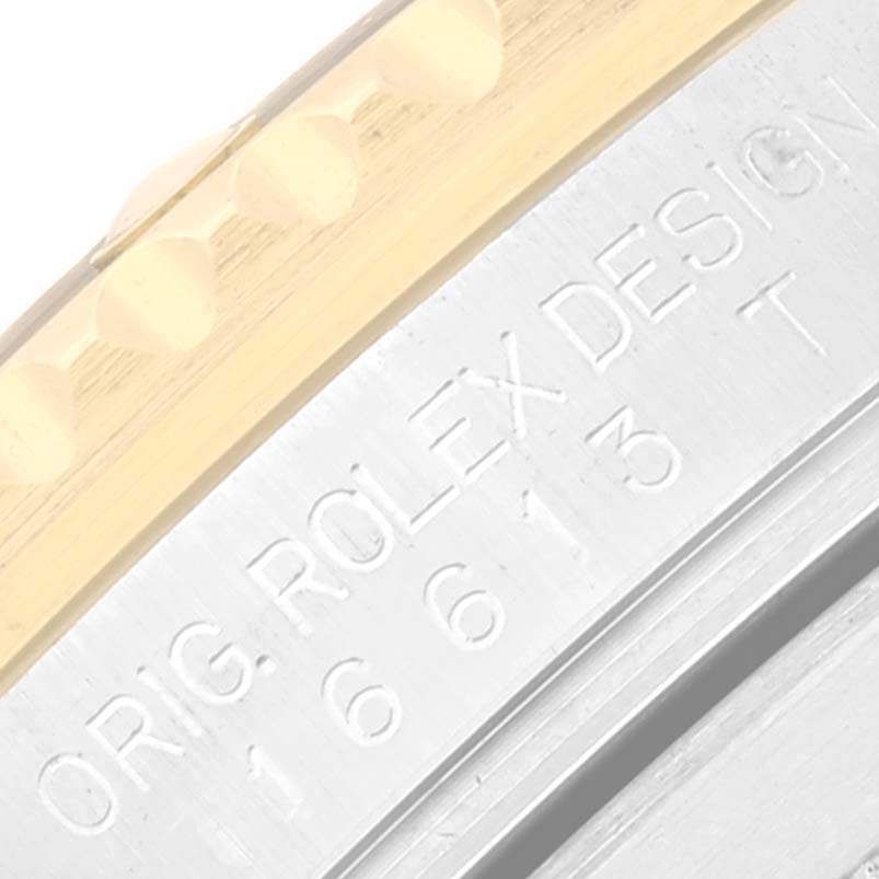 This close-up image shows the engraved markings on the case side and bezel edge of a Rolex Submariner 16613 Men's Steel and Gold (two tone) Blue Dial 16613 Men's Steel and Gold (two tone) Blue Dial watch.