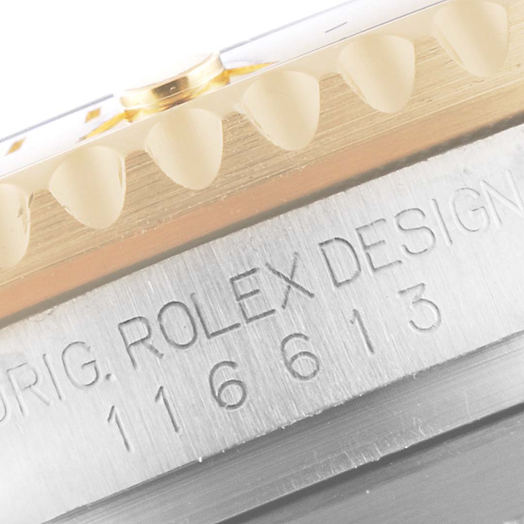 This close-up image shows the side view of the Rolex Submariner 116613 Men
s Steel and Gold (two tone) Blue Dial 116613 Men
s Steel and Gold (two tone) Blue Dial
s bezel and engraved model number.