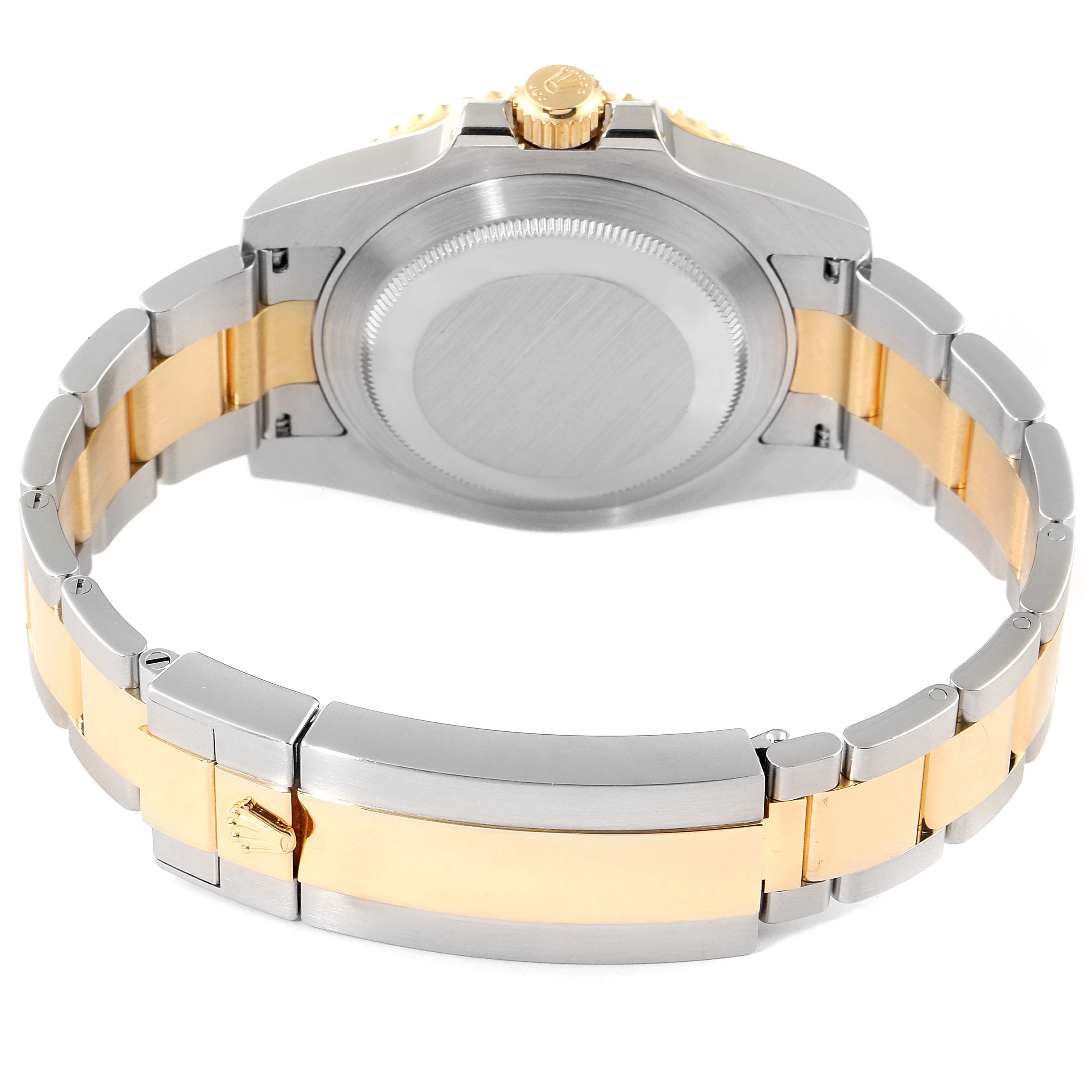 The image shows the back view of a Rolex Submariner 116613 Men
s Steel and Gold (two tone) Blue Dial 116613 Men
s Steel and Gold (two tone) Blue Dial watch, focusing on the case back, crown, and two-tone bracelet.