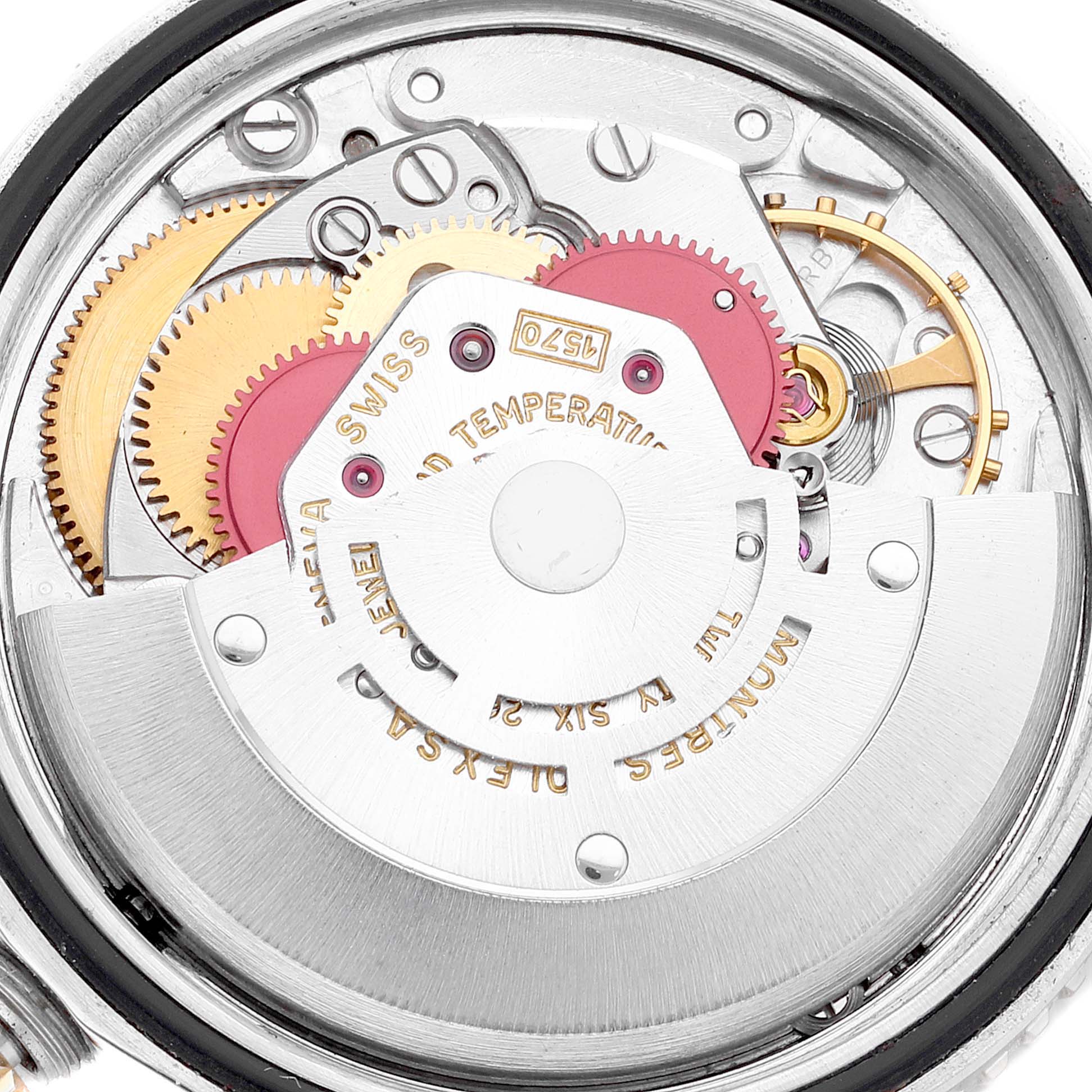 This is a close-up view of the internal mechanism of a Vintage Collection Rolex model, showing gears and movement components.