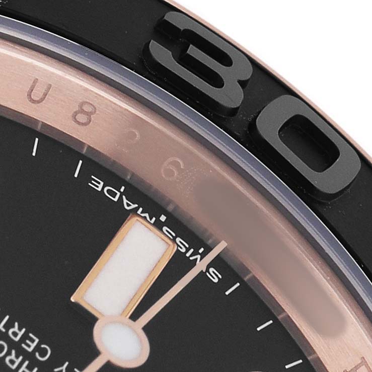 The image shows a close-up of the Rolex Yacht-Master 116655 Men's Rose Gold Black Dial's black bezel and part of the dial, capturing the numeral "30" prominently.