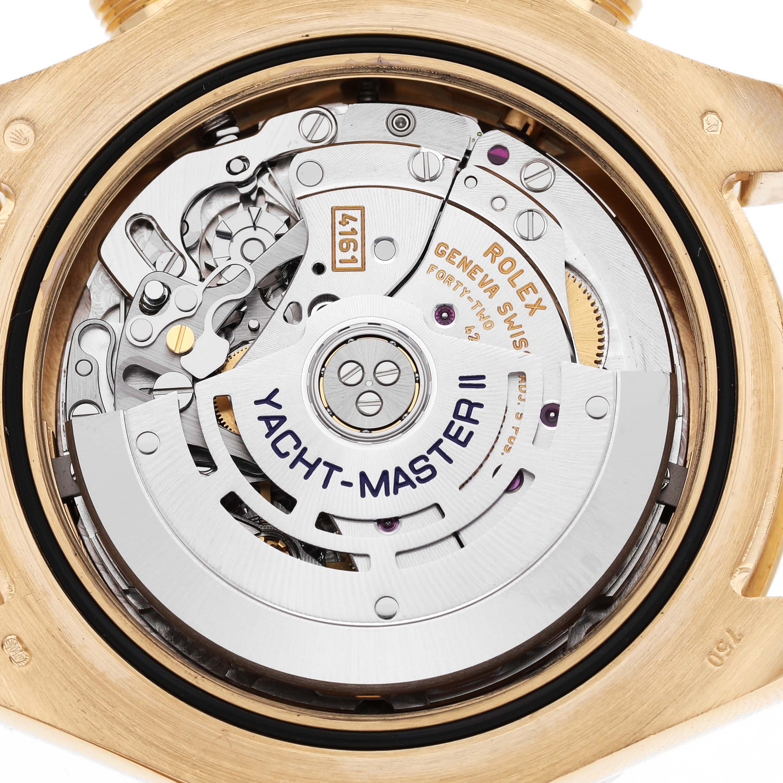 The image shows the intricate movement of a Rolex Yacht-Master 116688 Men's Yellow Gold White Dial II watch from the back, highlighting its internal mechanism.