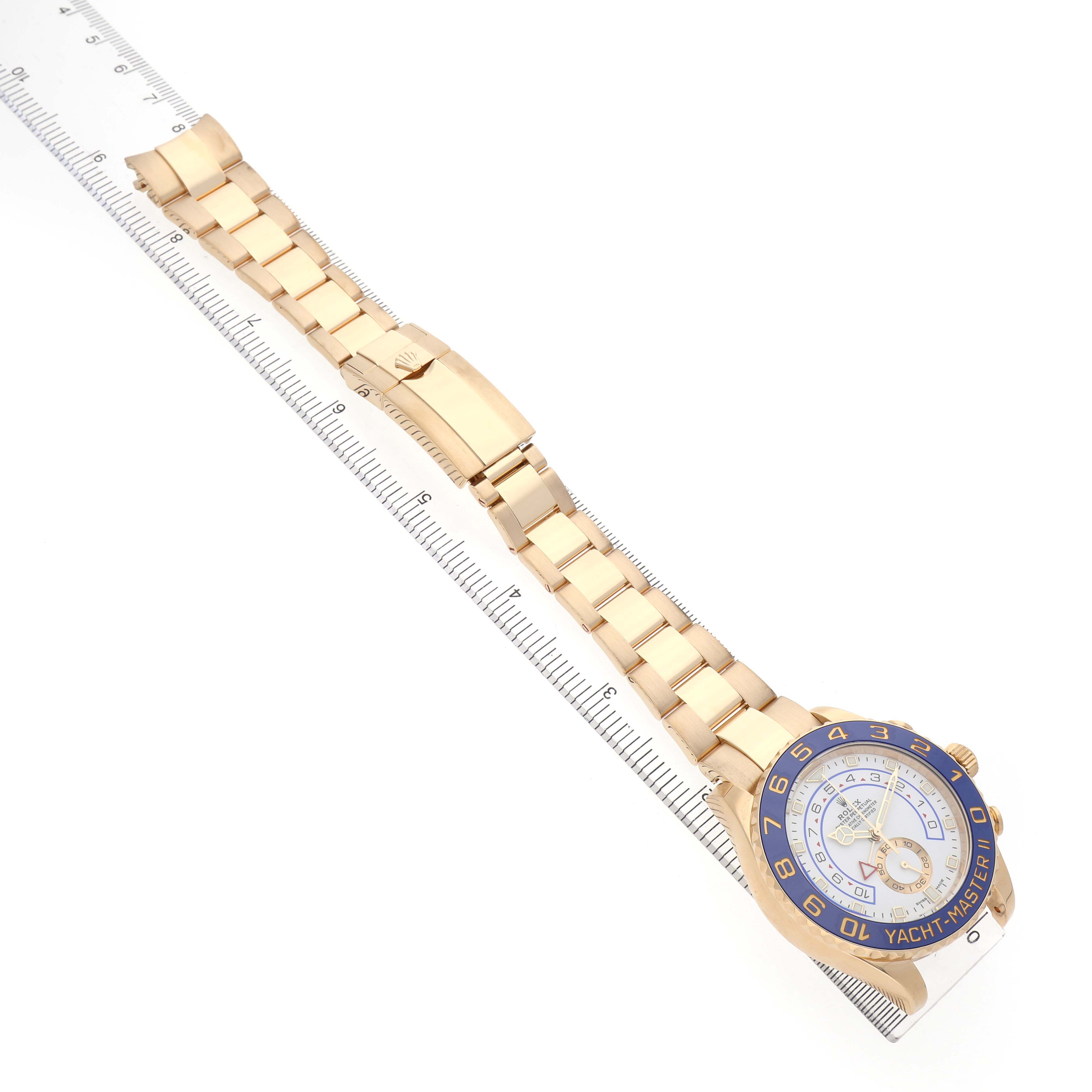 The image shows a Rolex Yacht-Master 116688 Men's Yellow Gold White Dial watch from a top angle, highlighting its face, bezel, bracelet, and folding clasp.