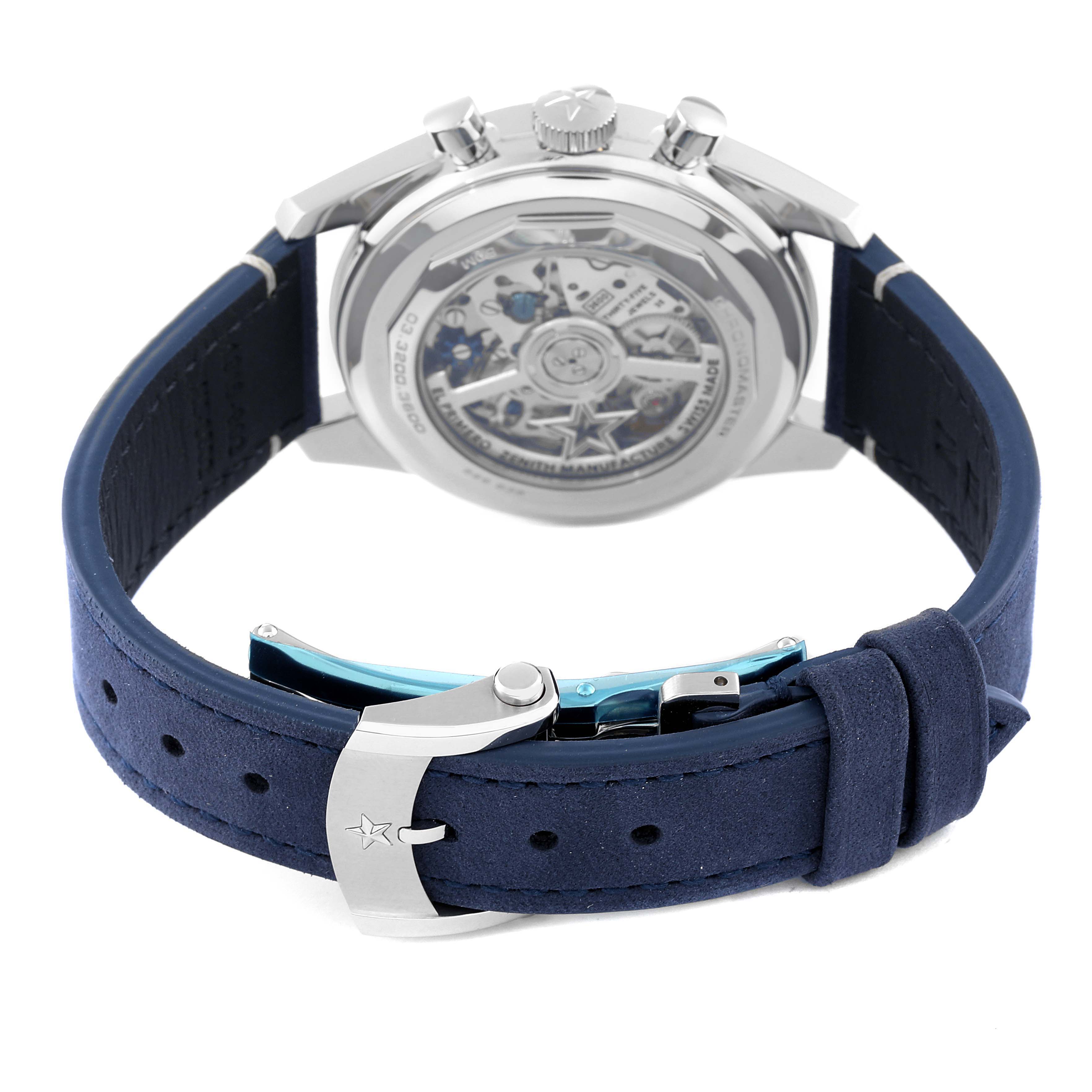 The image shows the back view of a Zenith Chronomaster 03.3200.3600 Men
s Stainless Steel White Dial 03.3200.3600 Men
s Stainless Steel White Dial watch, highlighting its case back, crown, and blue strap.