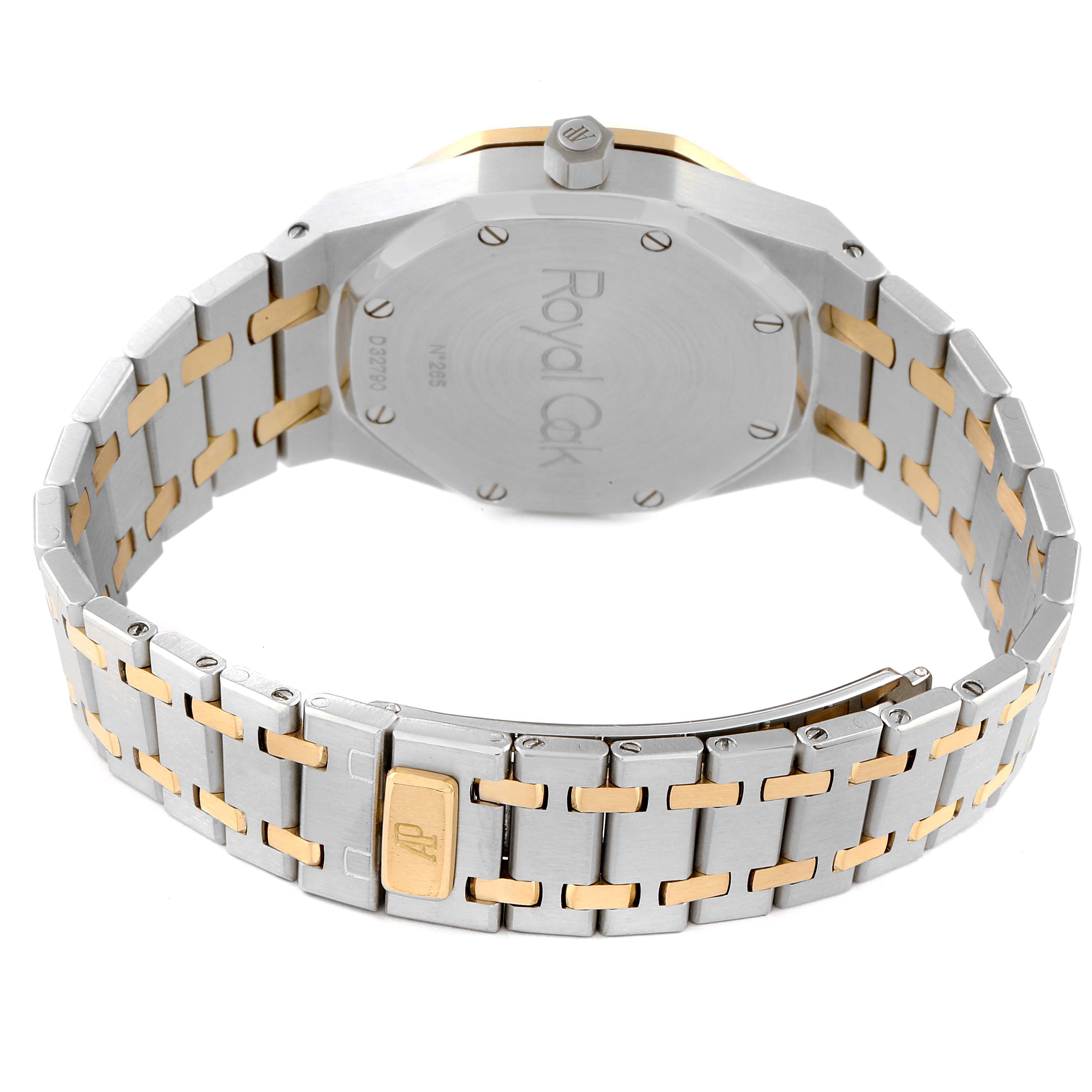 The image shows the back view of a Royal Oak by Audemars Piguet, featuring the case back, crown, and two-tone bracelet.
