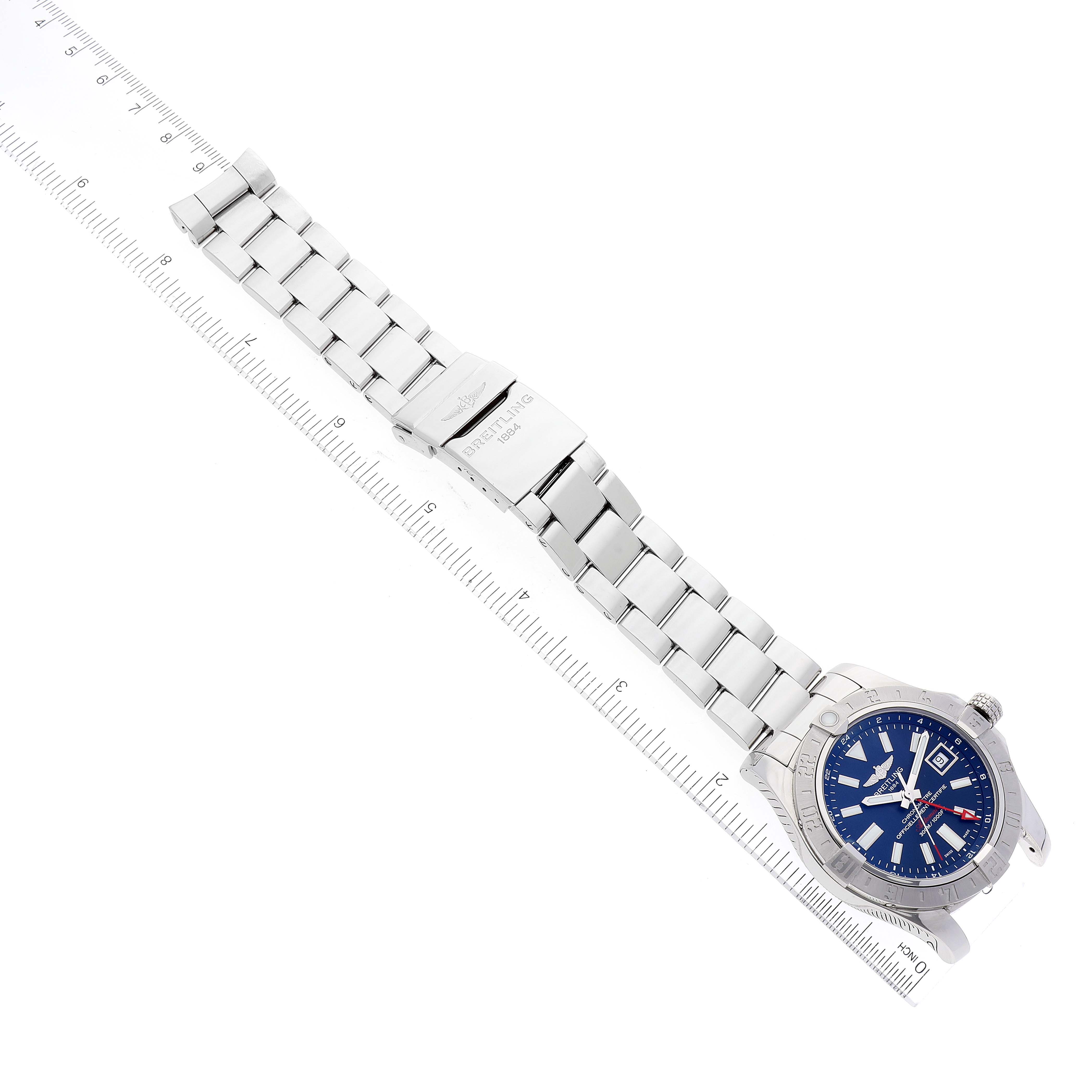 This is a top view of a Breitling Avenger A3239011-C872-170A Men's Stainless Steel Blue Dial A3239011-C872-170A Men's Stainless Steel Blue Dial watch showing the full bracelet, clasp, and watch face next to a ruler for scale.