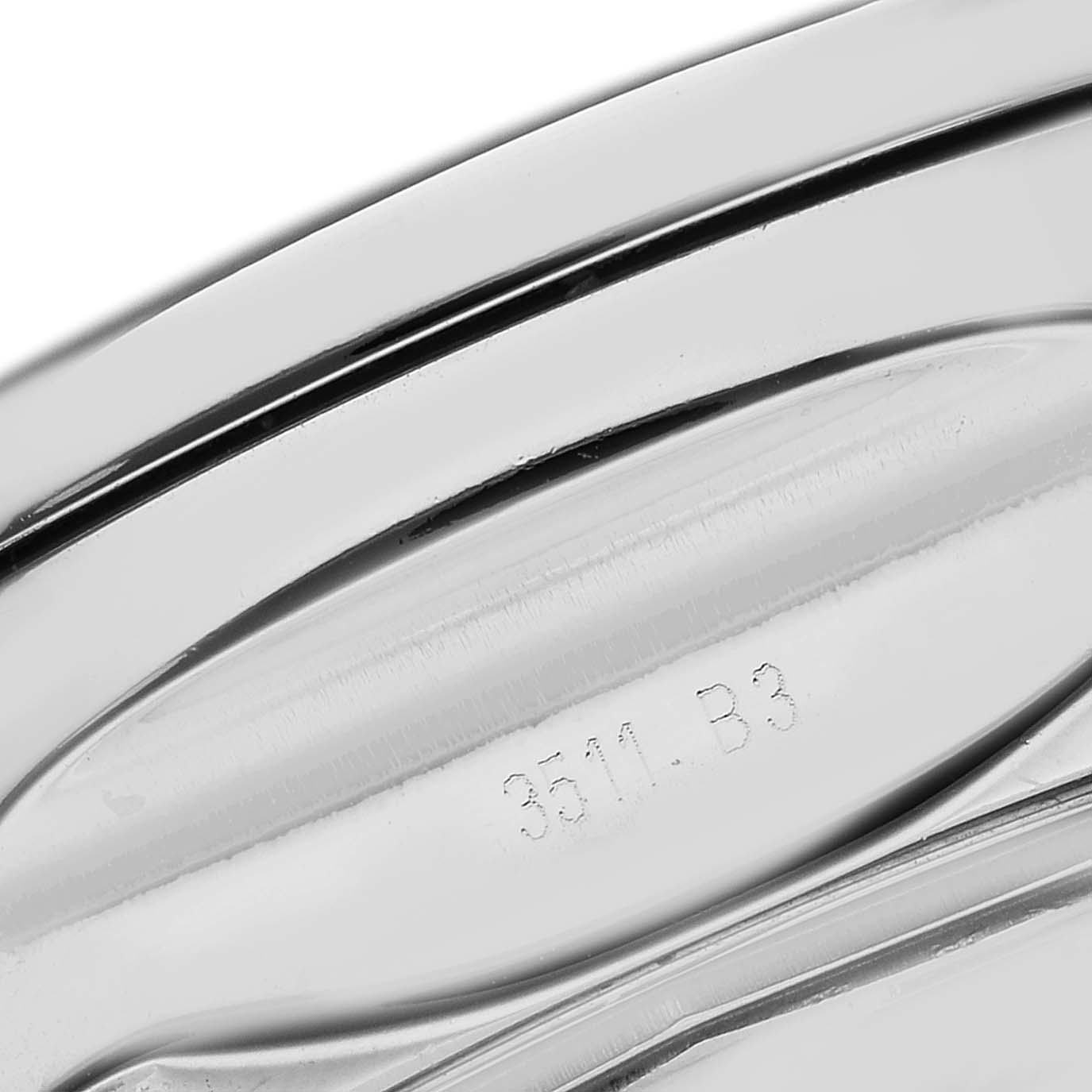 The image shows a close-up of the stainless steel back of a Bentley model by Breitling, highlighting a serial number engraving.