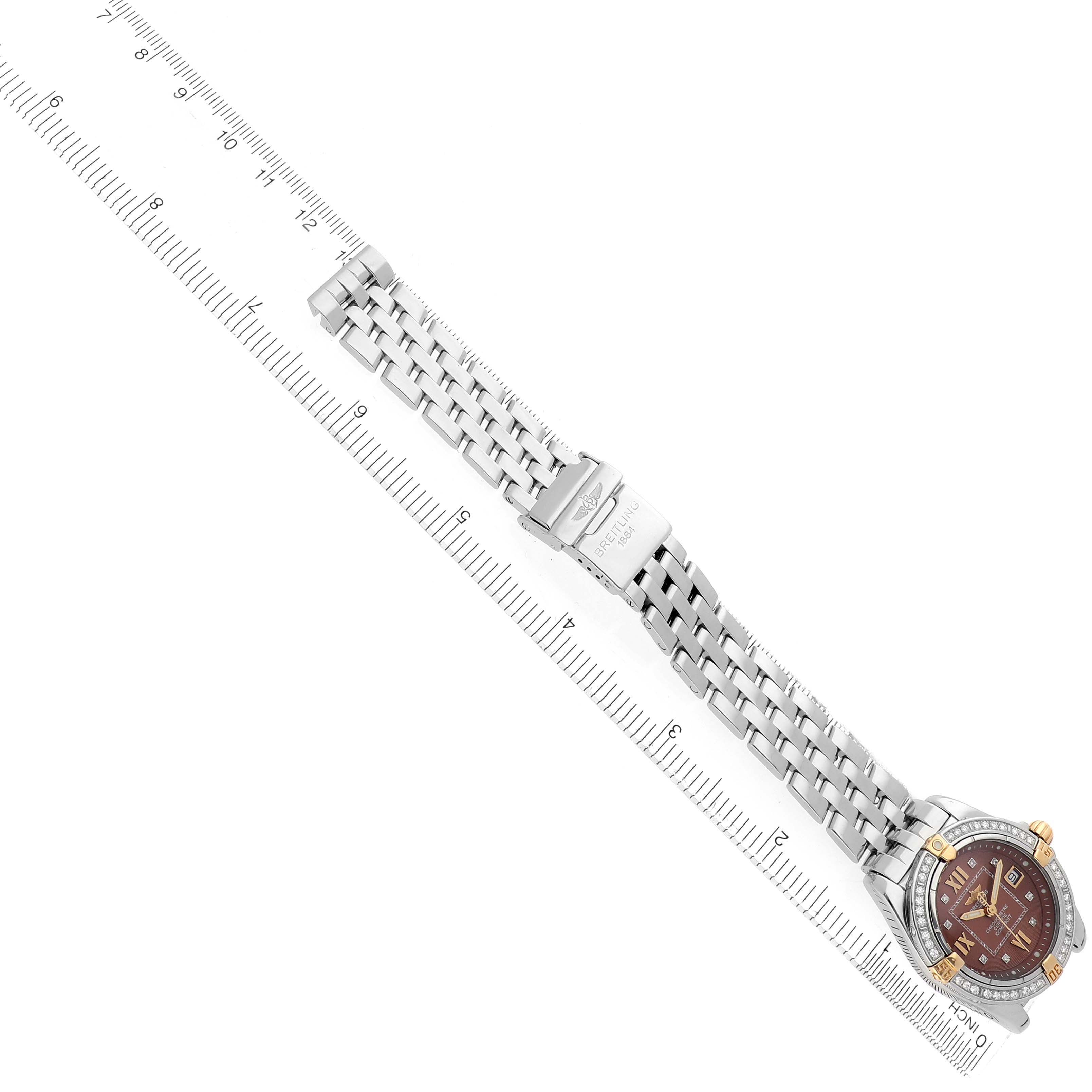 The Breitling B71356 Women
s Steel and Gold (two tone) Orange Dial Cockpit Steel Bronze Diamond Bezel Dial Ladies Watch B71356 is shown from a top-down angle, displaying the full bracelet and clasp.