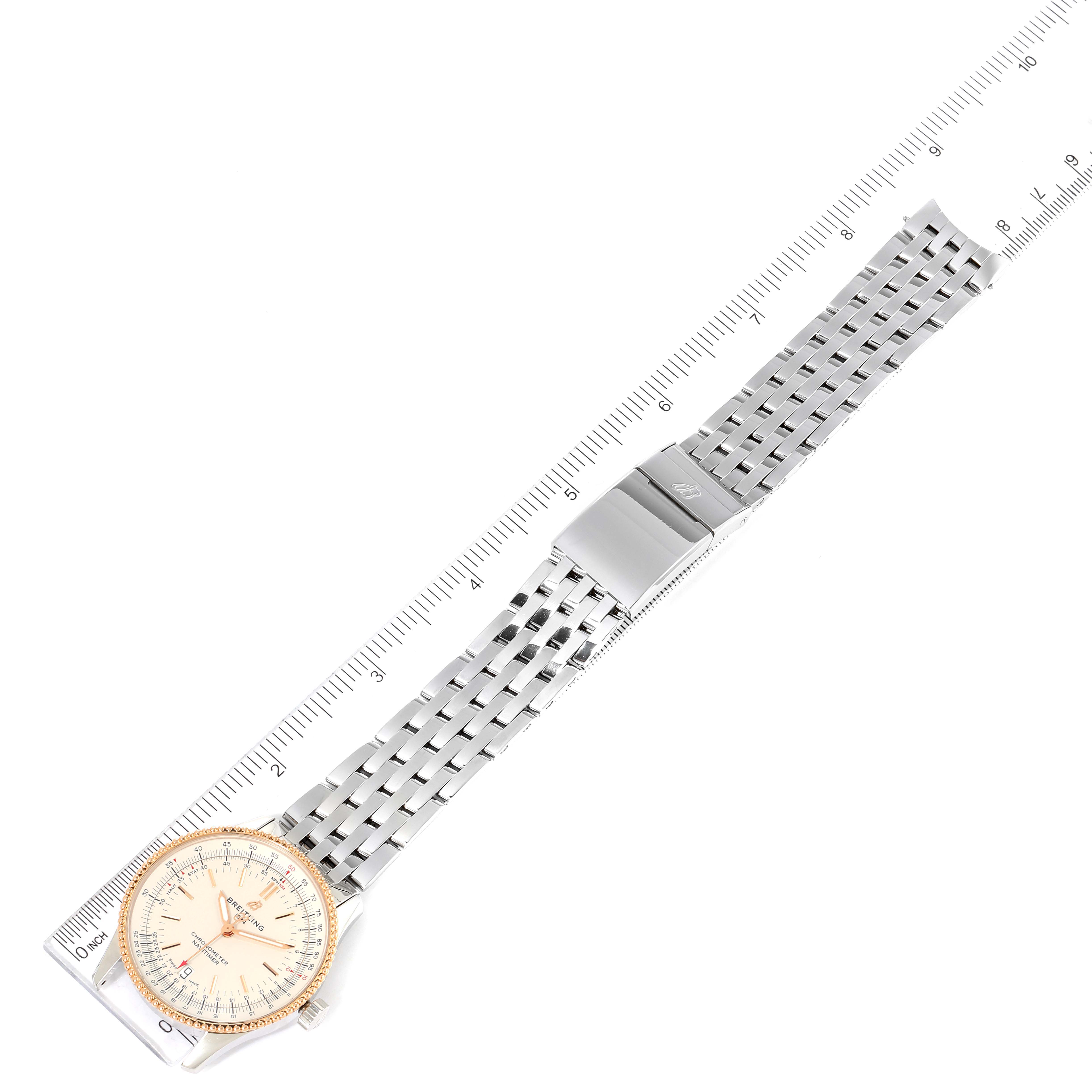 The Breitling Navitimer U17325211G1A1 Men's Stainless Steel Silver Dial U17325211G1A1 Men's Stainless Steel Silver Dial watch is shown from a top-down angle, displaying the dial, bezel, and full bracelet with a ruler for scale.